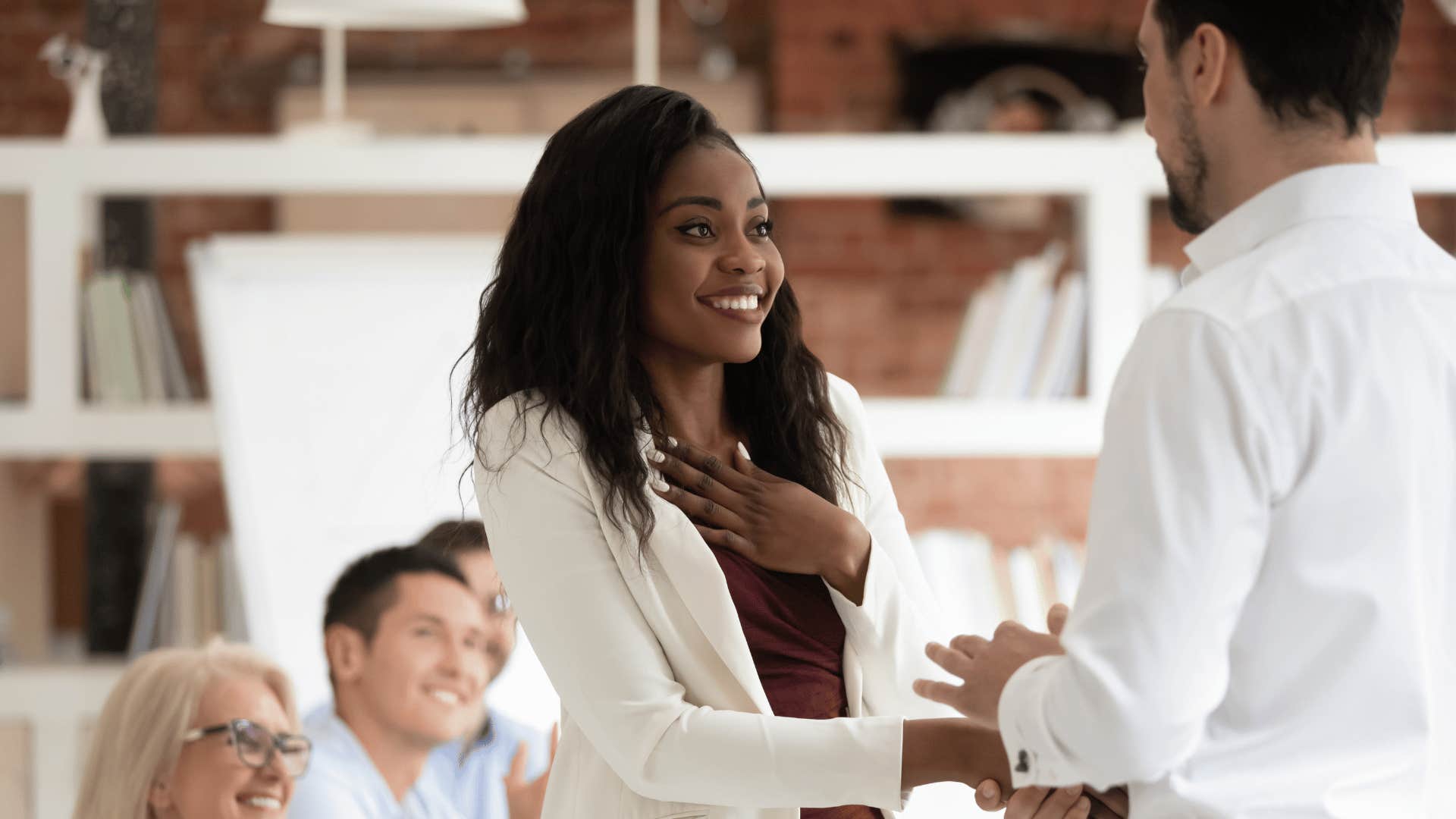 woman shaking hands with a man