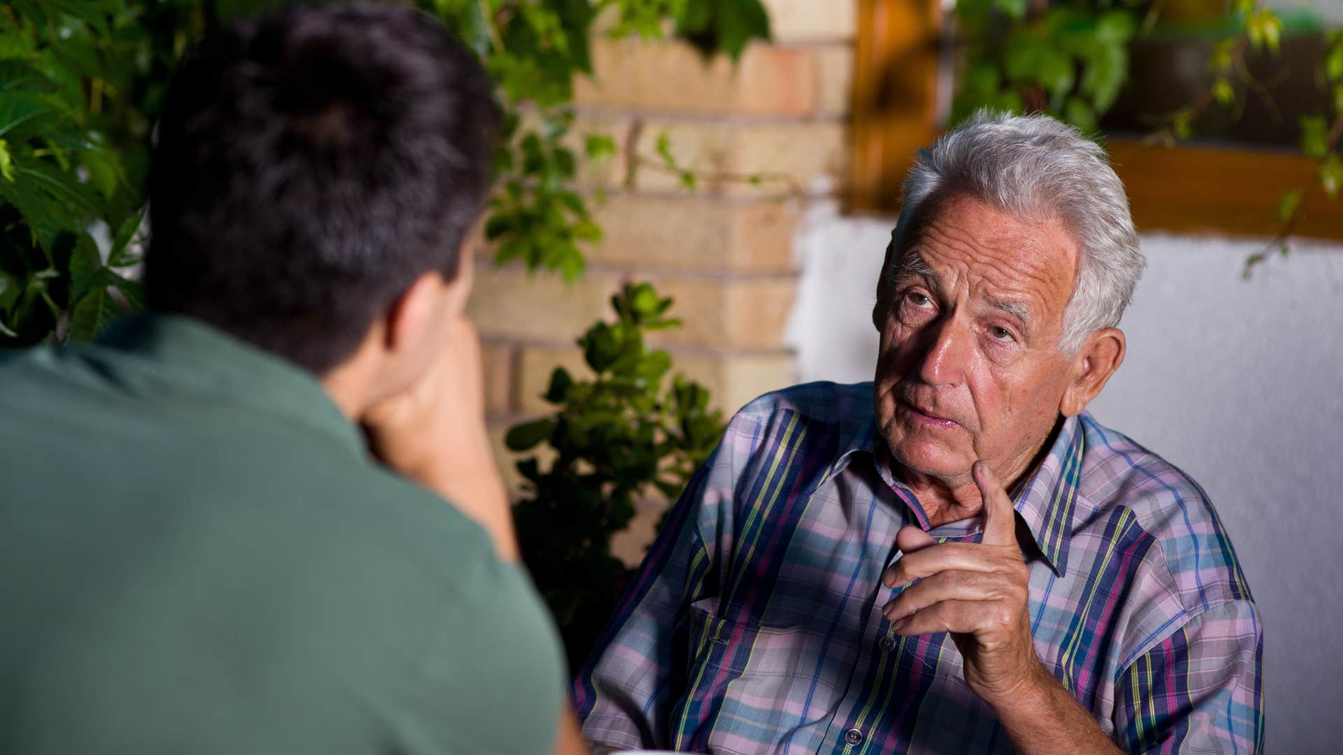 older man having a serious conversation with adult son