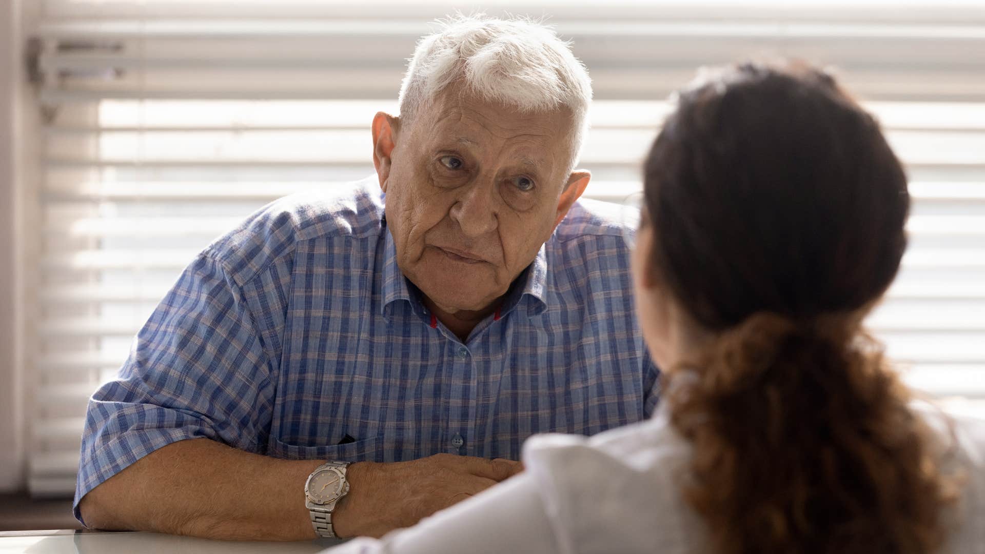 boomer man having serious conversation with young woman