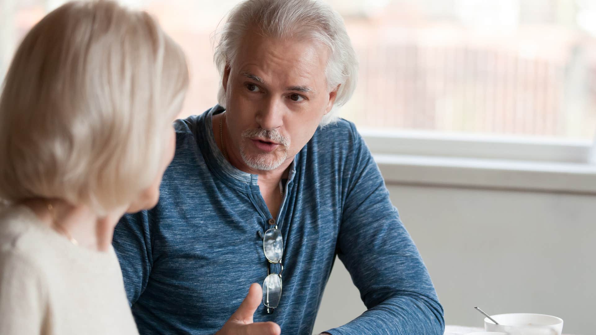 boomer man discussing consequences with wife