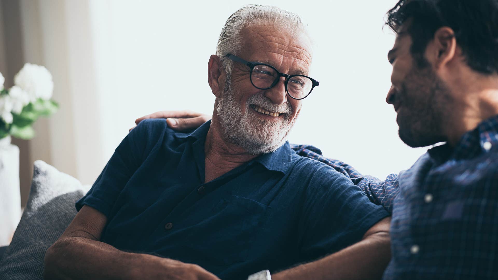 happy older man smiling with son