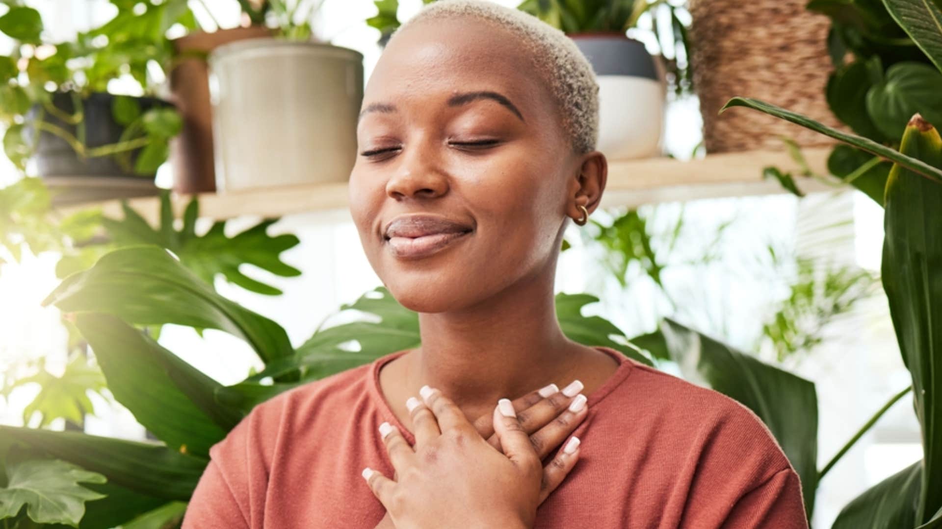 woman holding her heart to ground herself 