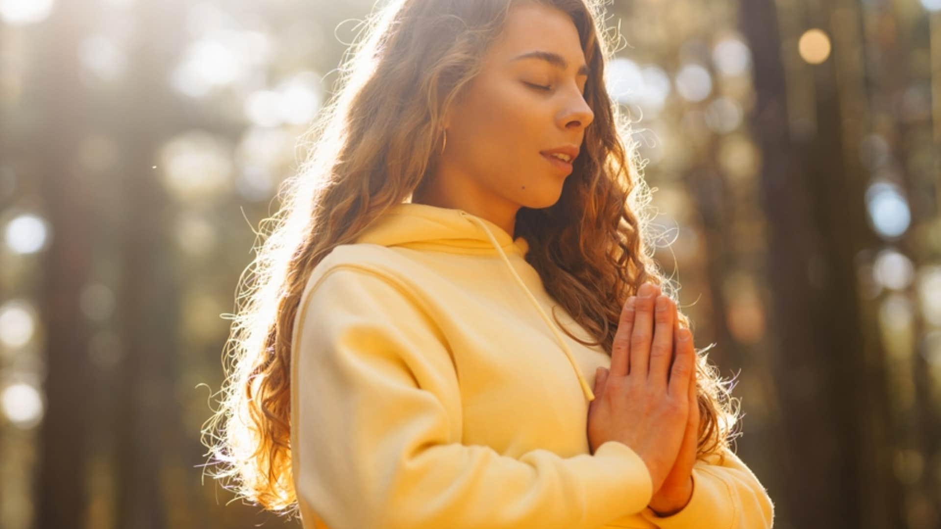 woman connecting with nature by meditating