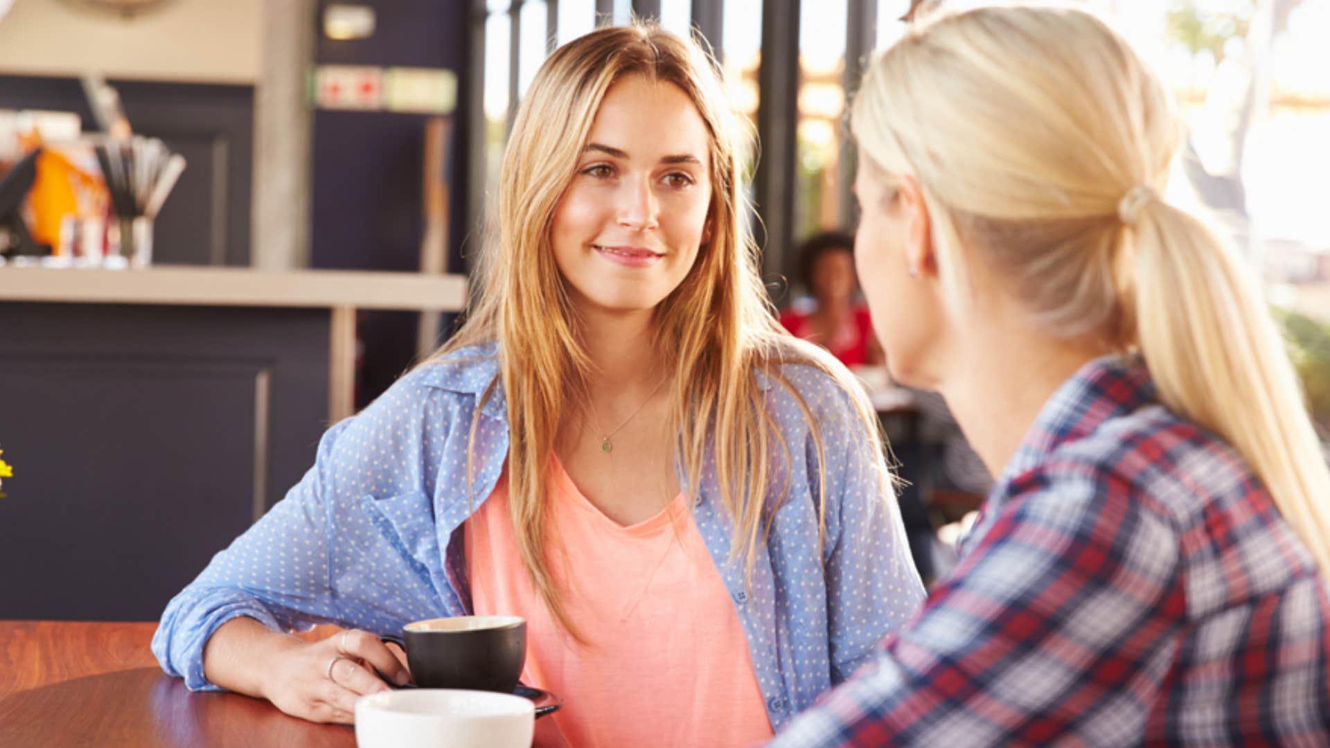 two women having a conversation over coffee