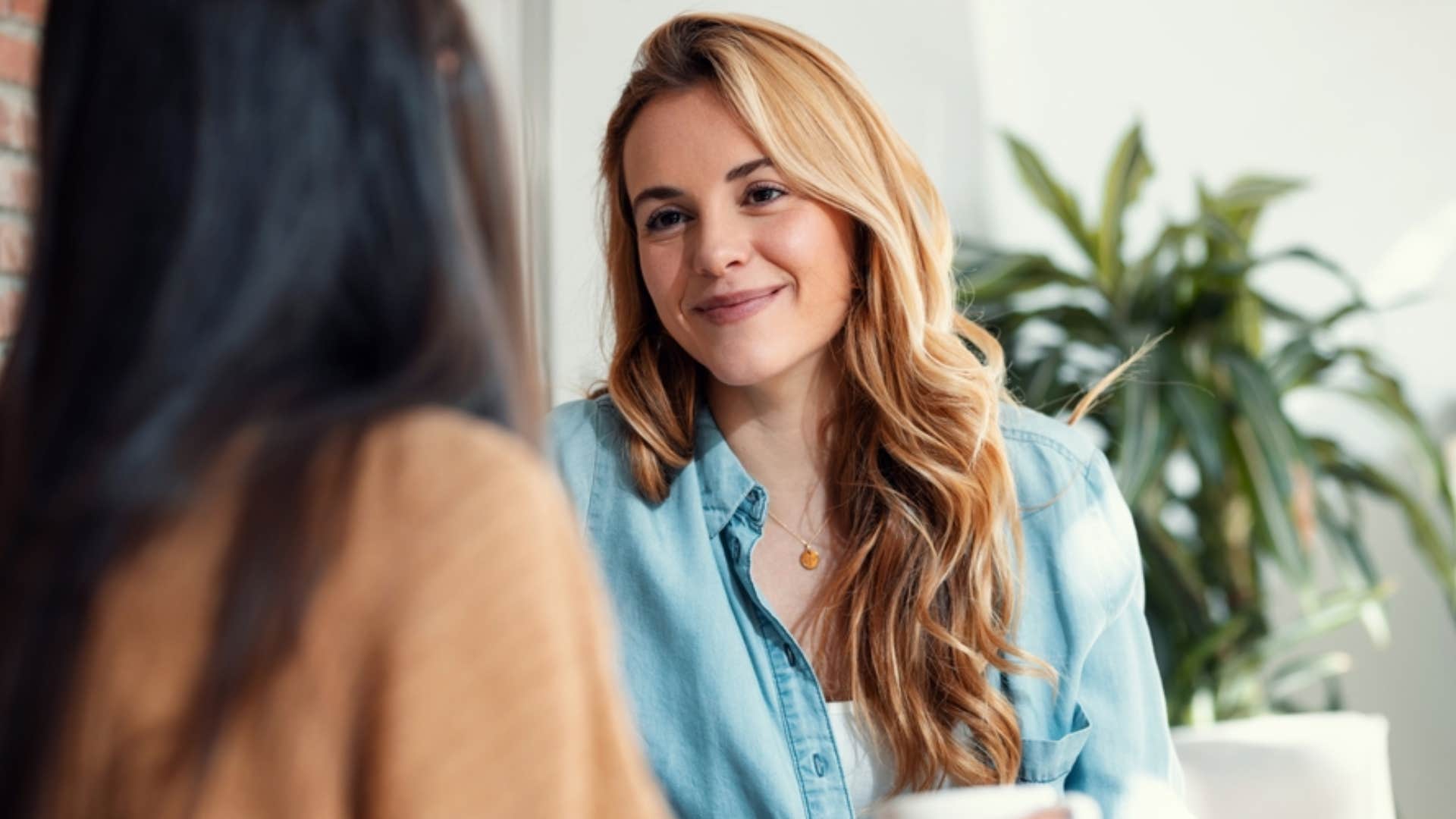 woman politely interrupting friend speaking