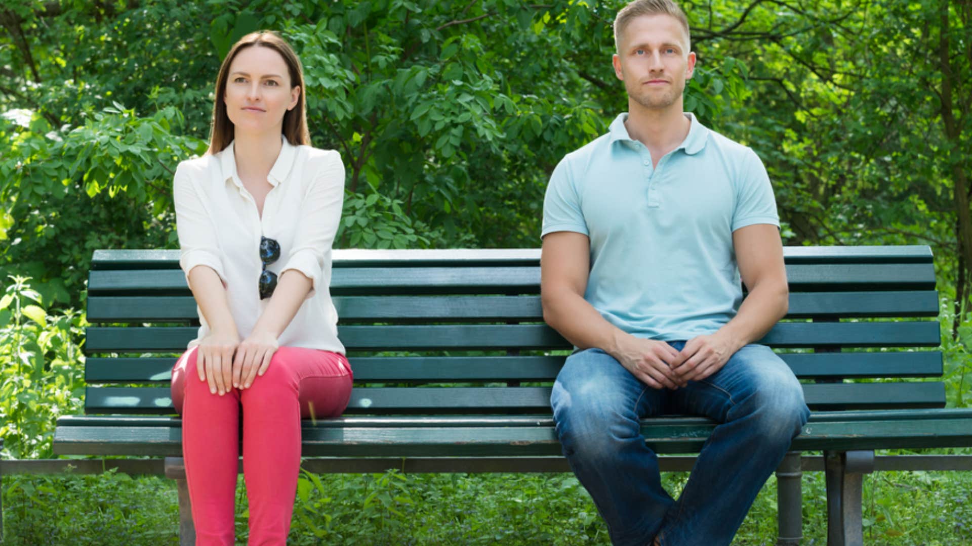 two people sitting in silence on bench