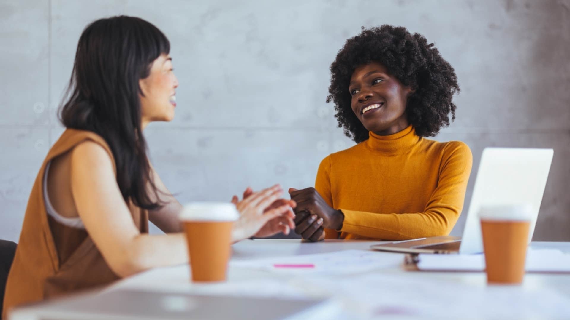 woman asking colleague to pause their conversation