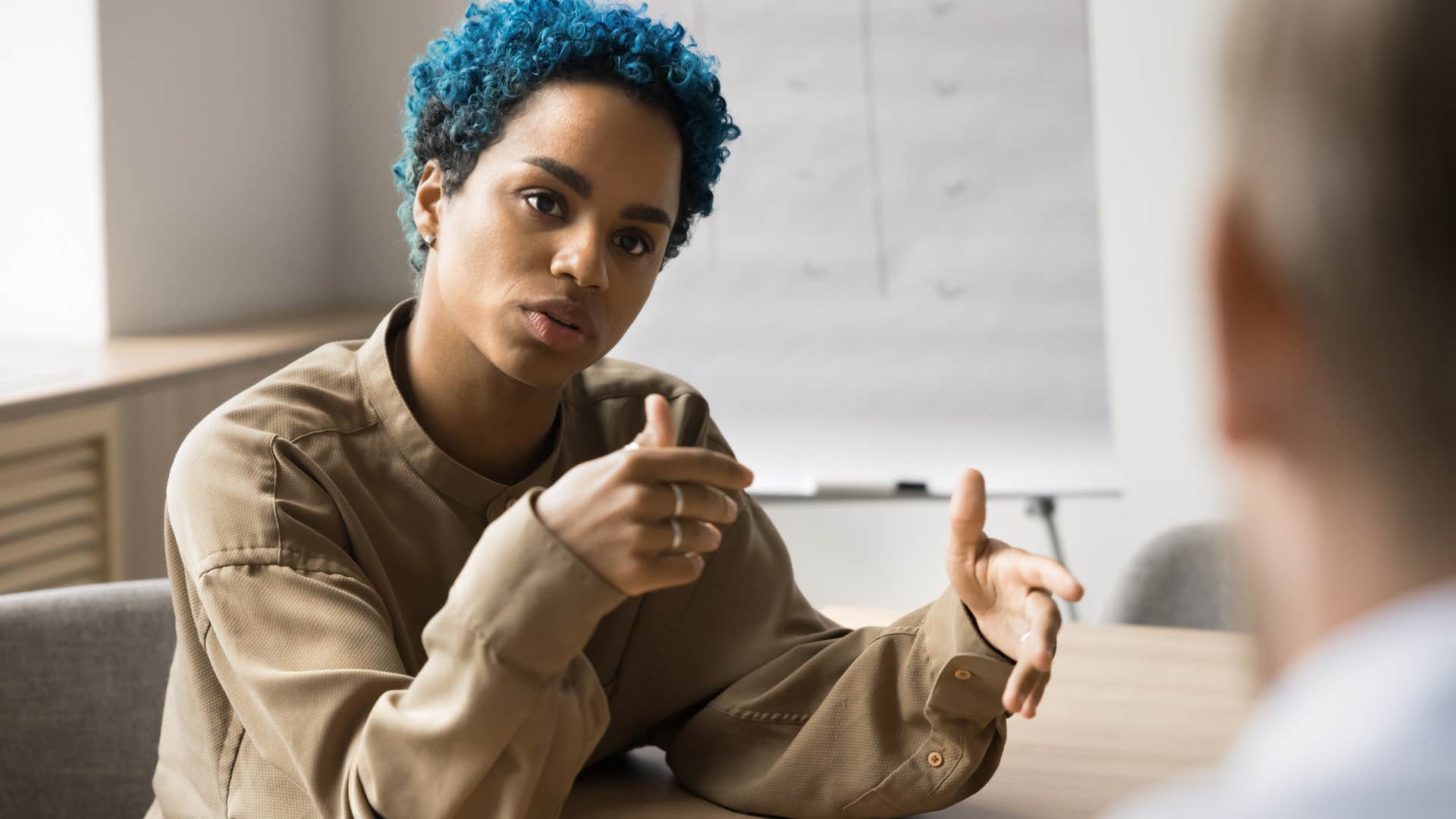 woman matter of factly arguing with colleague