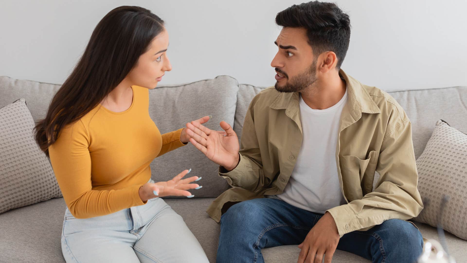 couple arguing on a couch