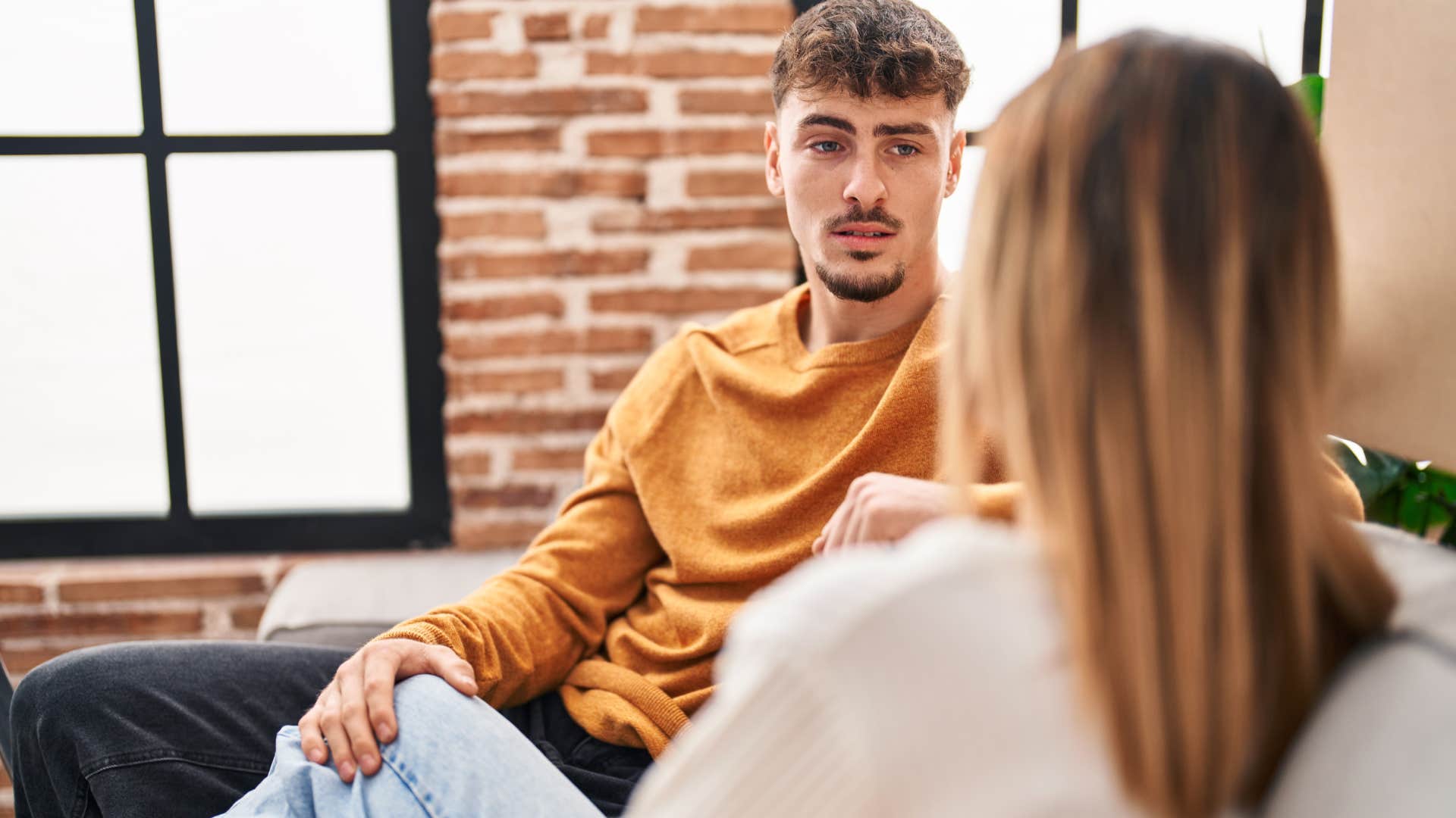 man listening to woman talk to him