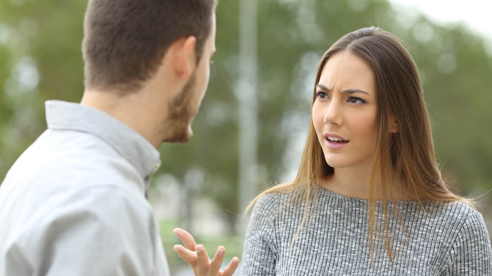 woman having conversation with man outside