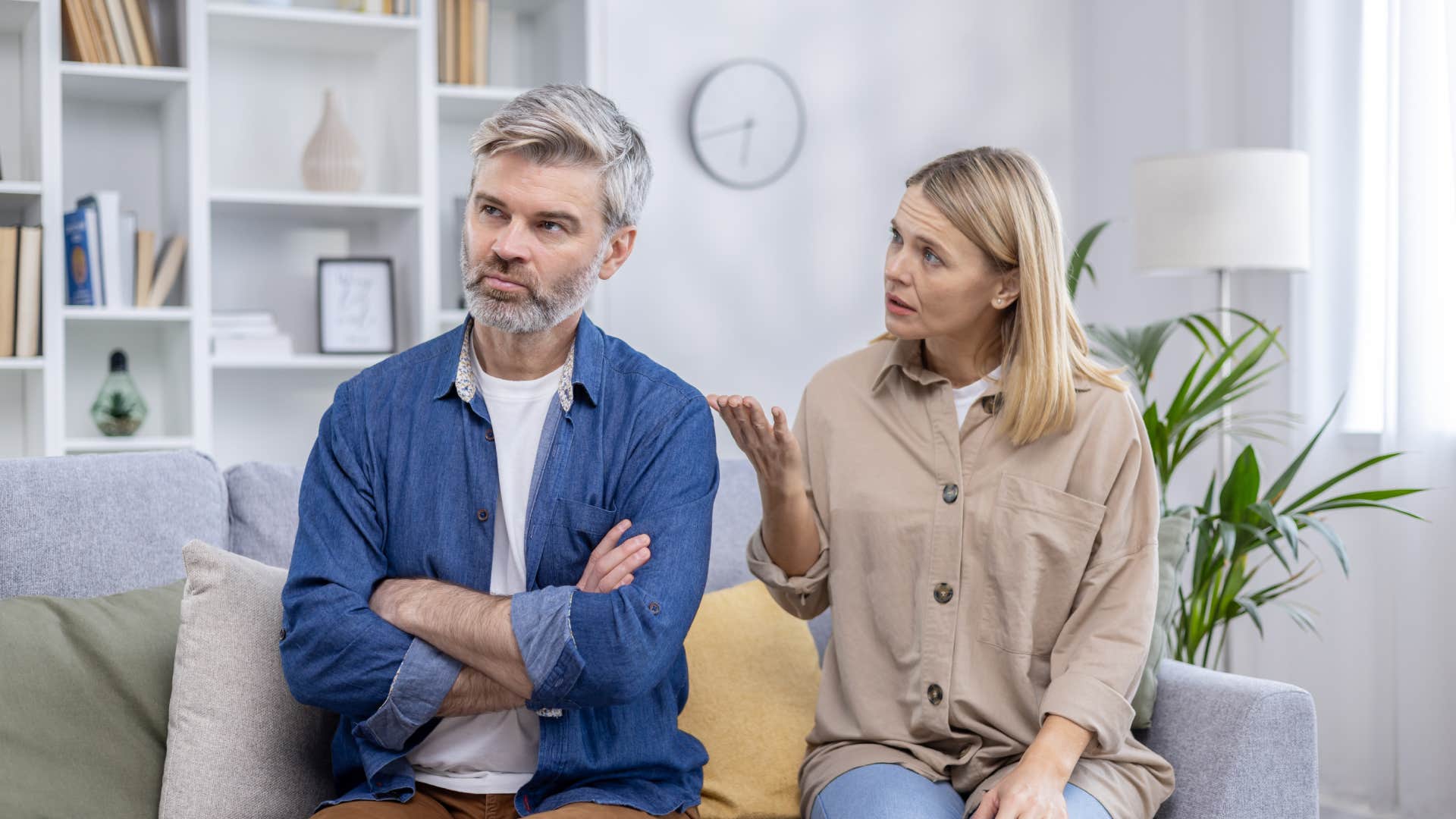 upset man listening while woman talks to him