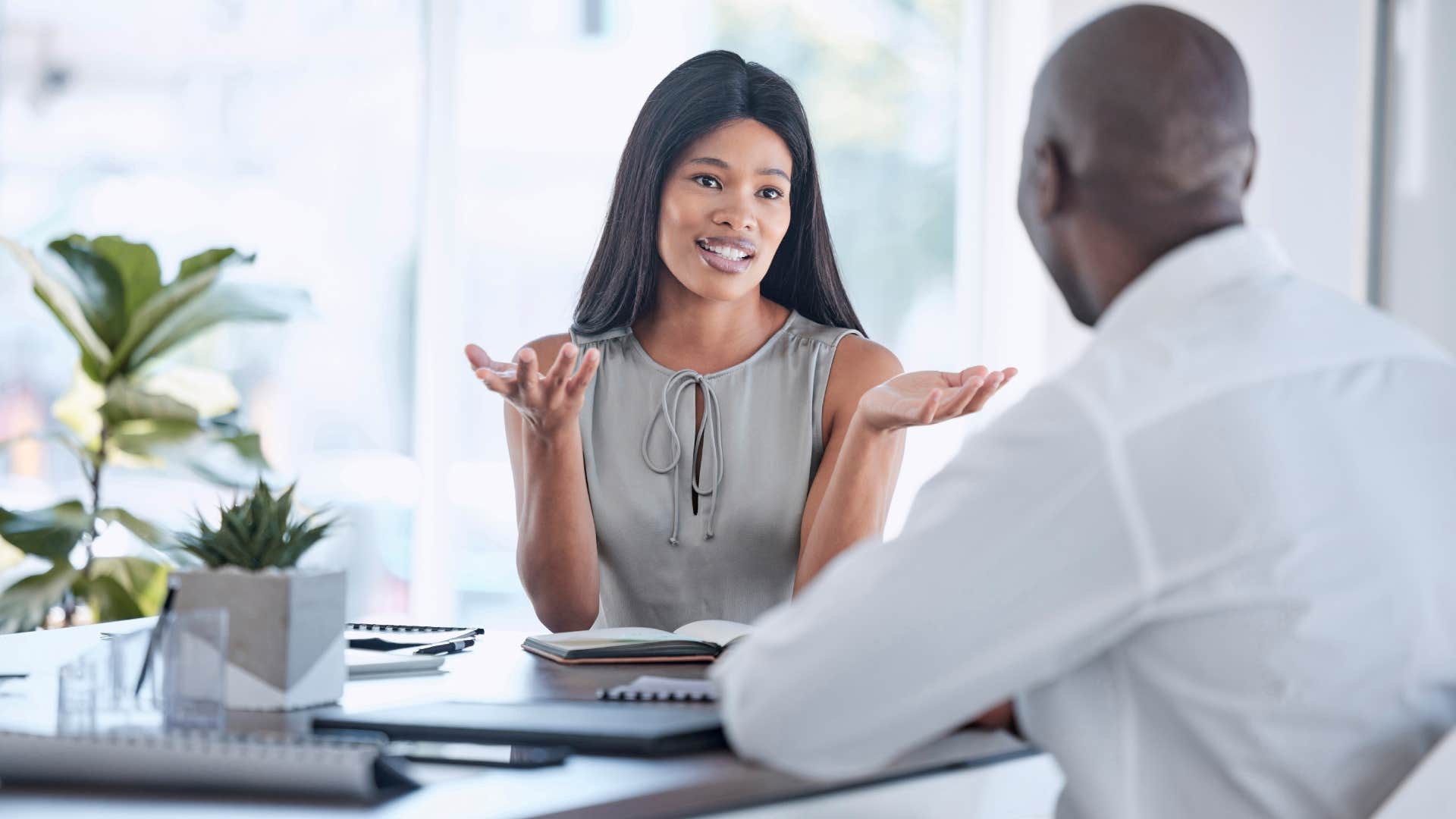 woman talking to businessman in office