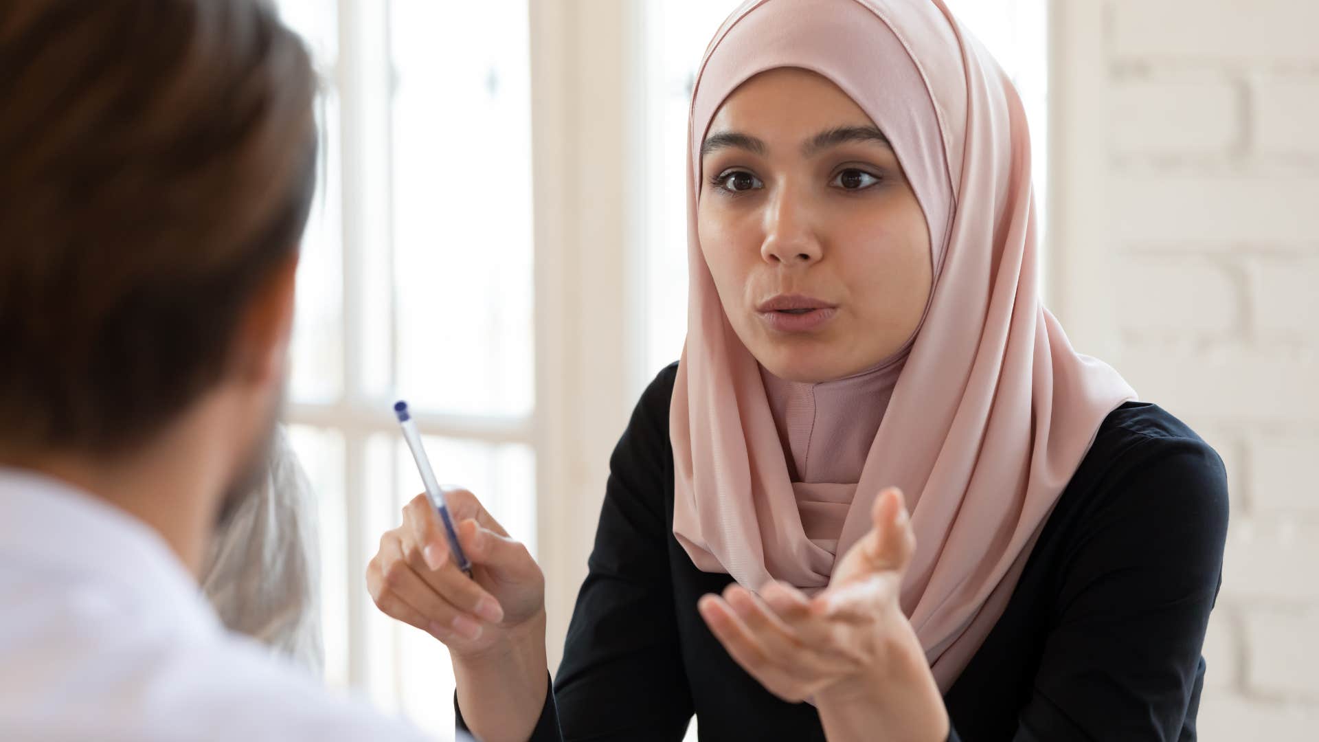 Upset woman talking to a man work.