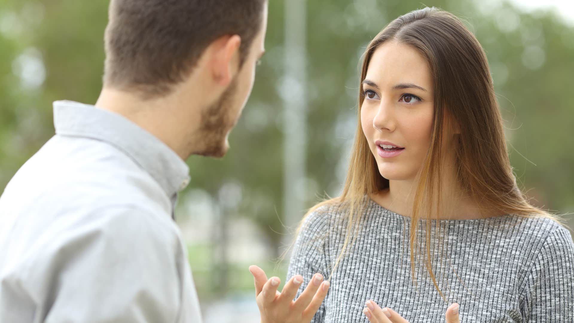 Woman talking to her partner outside.