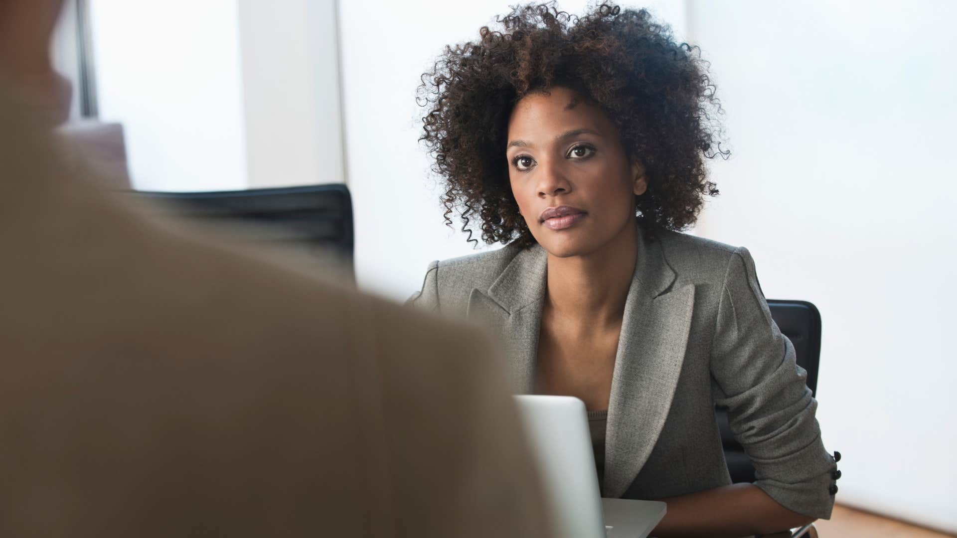 Upset woman looking at a man in an office