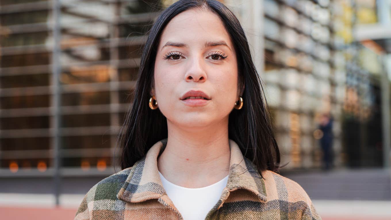 Confident young woman staring seriously into the camera.