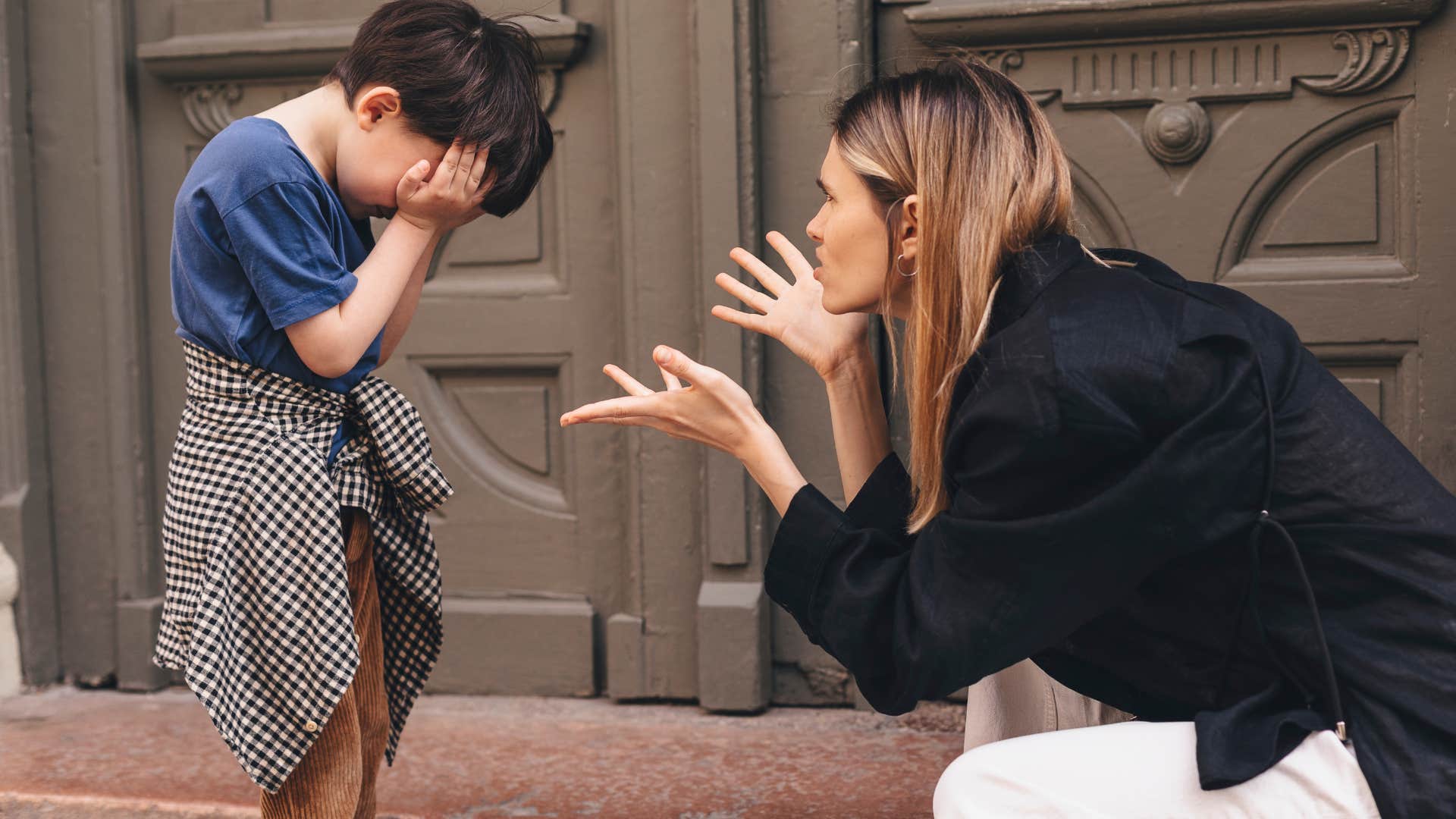 woman scolding crying young son