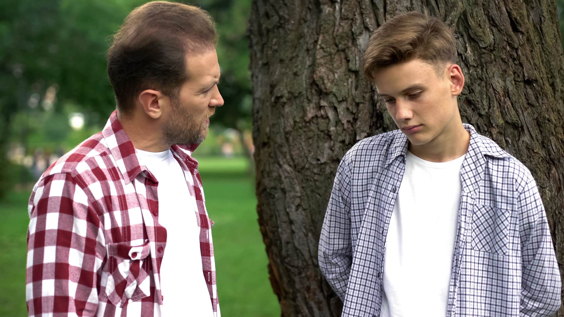 man having a serious conversation with his teenage son