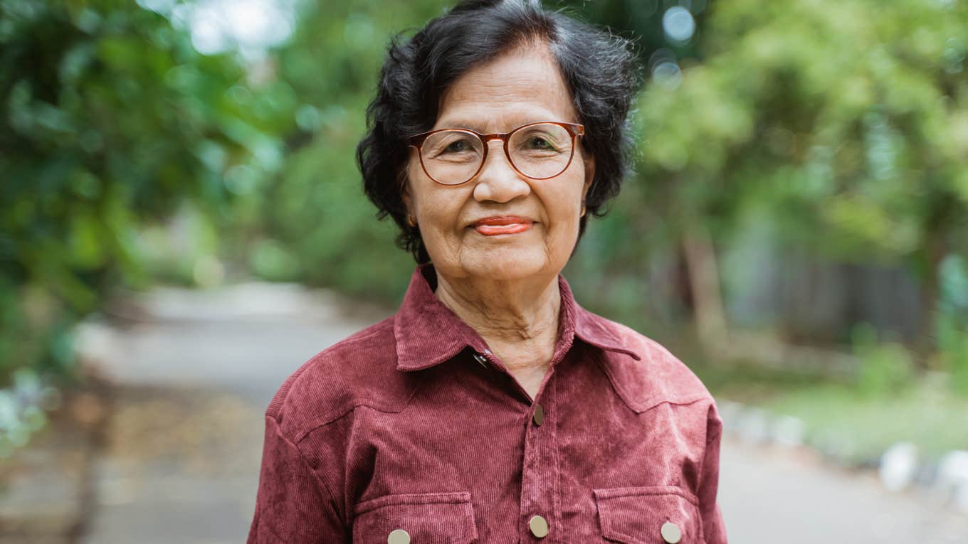 older woman smiling thinking about being a parent