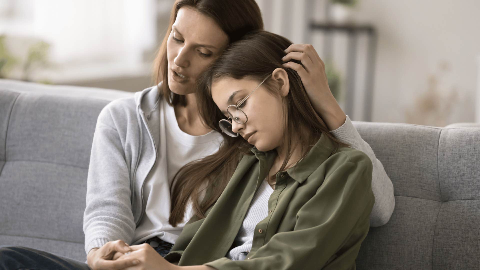 mother comforting daughter