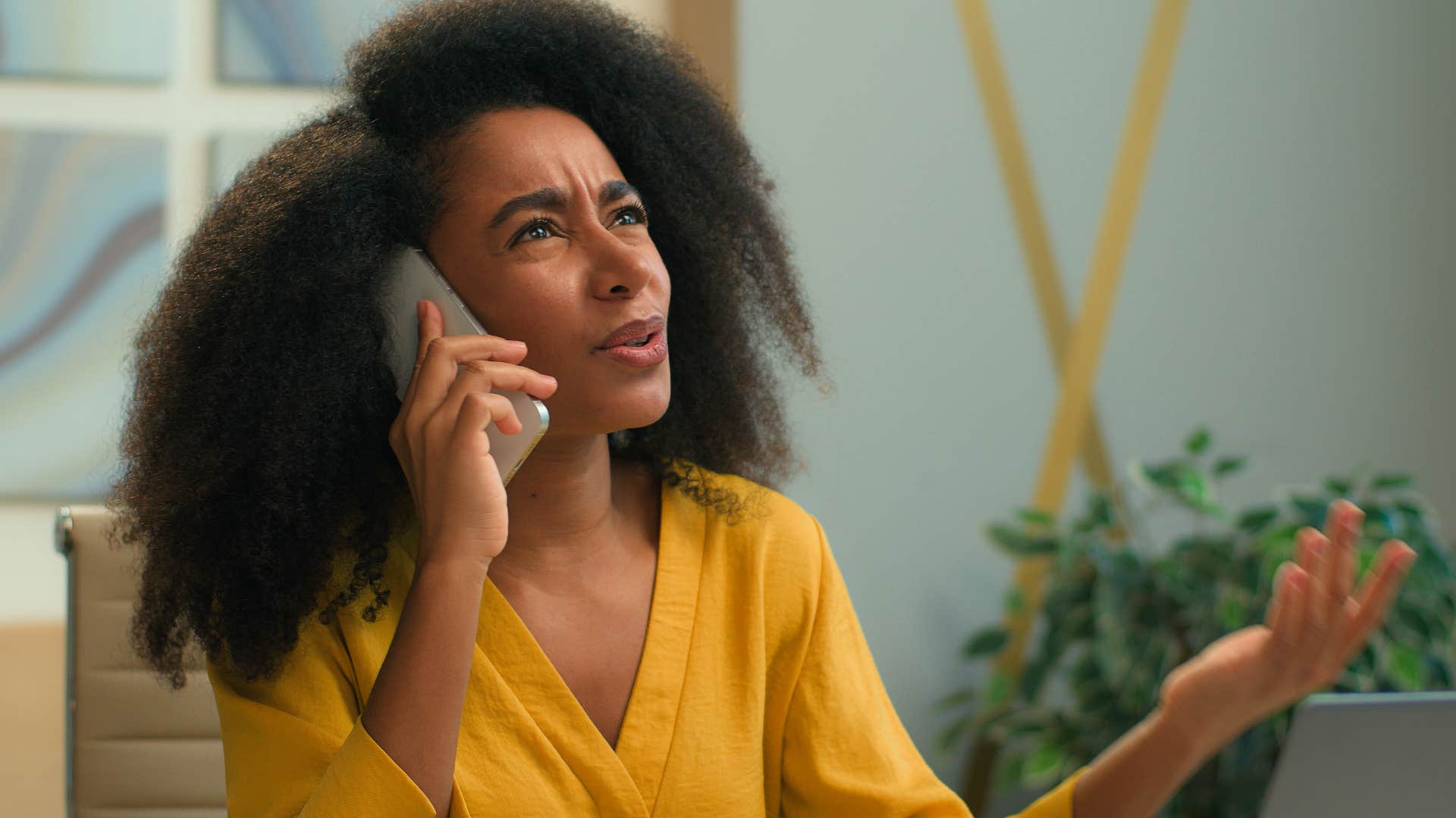 upset woman talking on the phone with disapproving parent