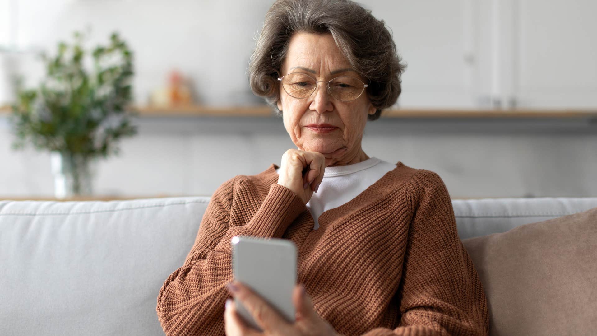 lonely older woman waiting for someone to call