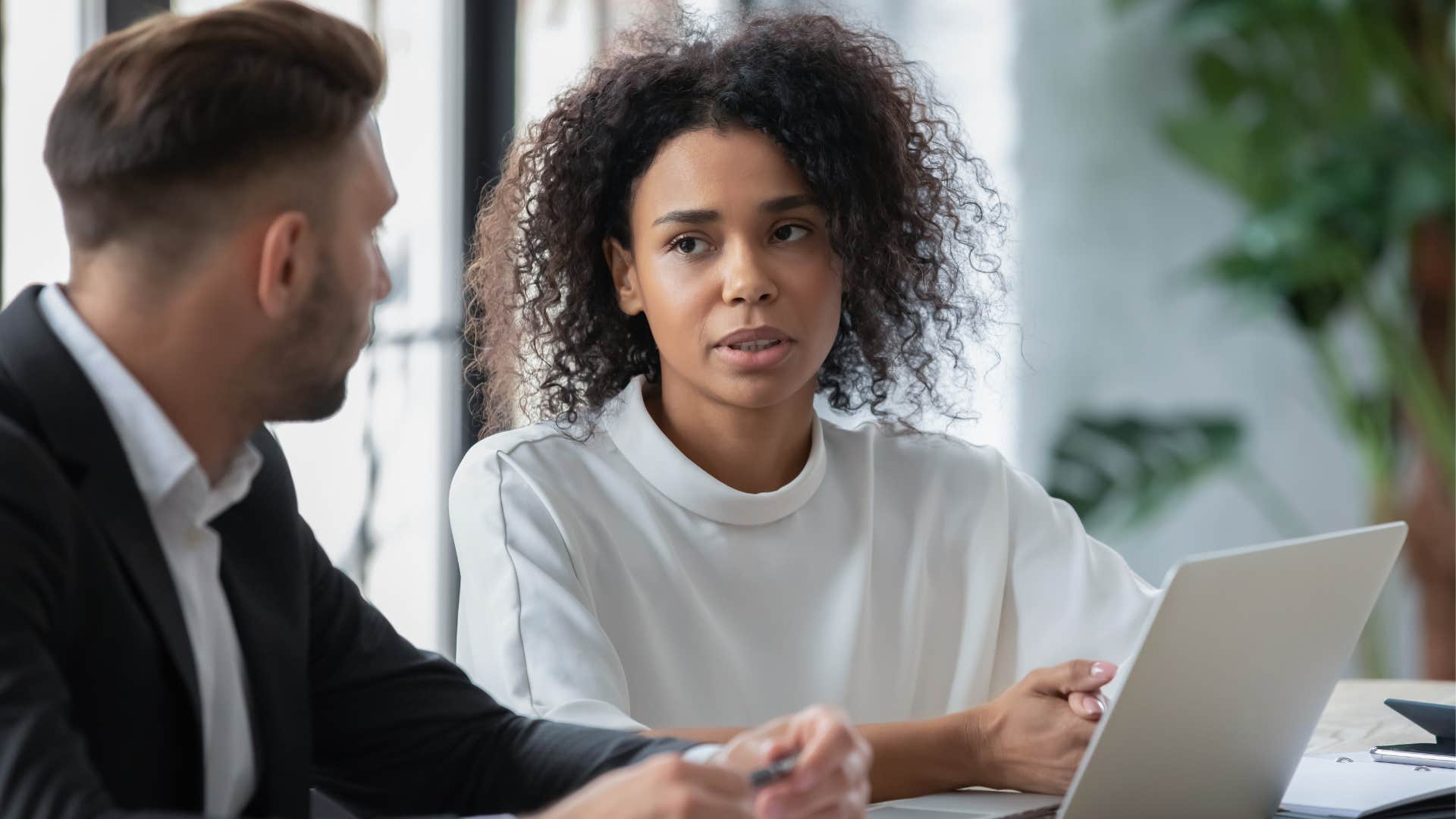 A woman tells her coworker he was right about a situation.