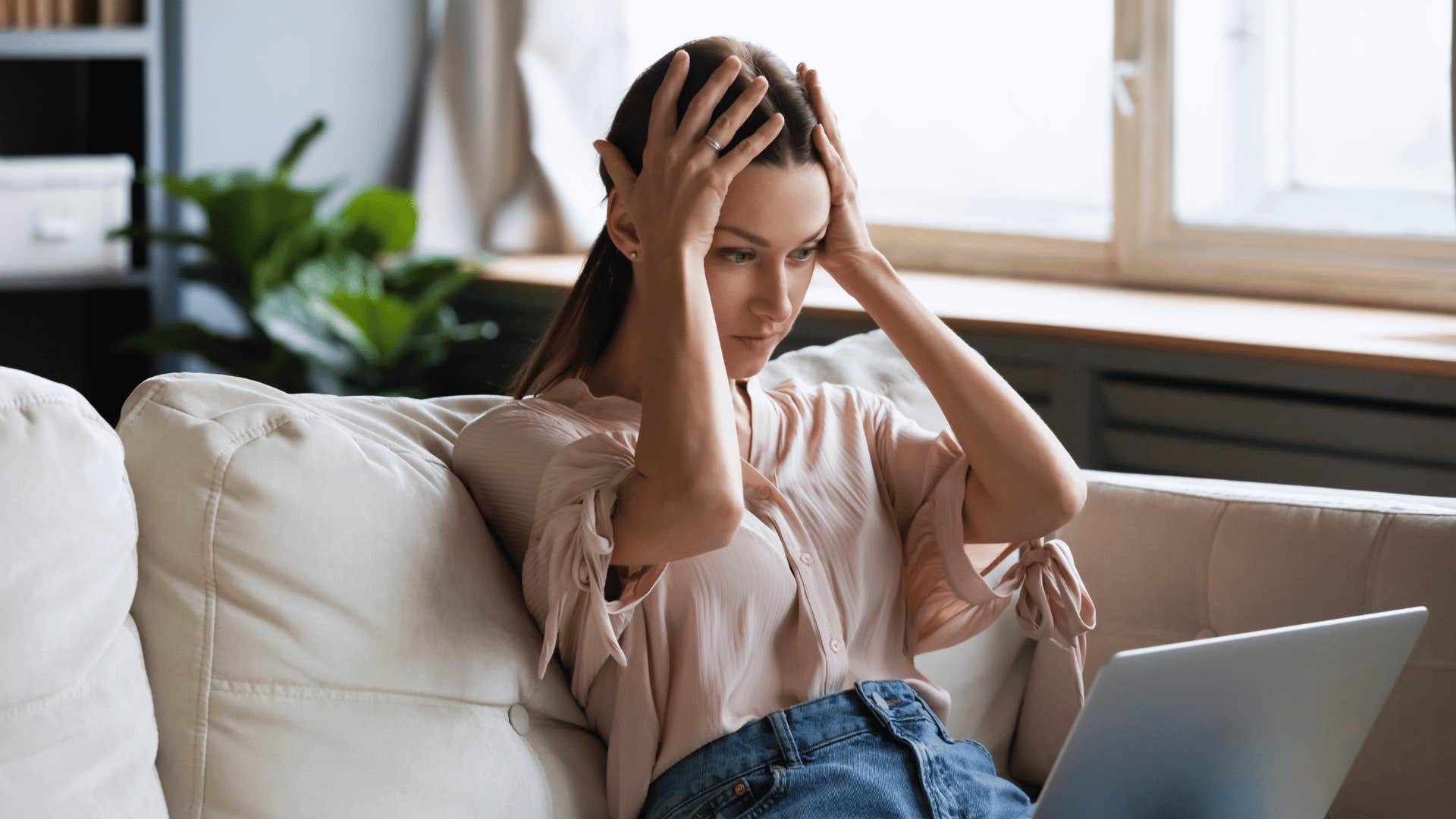 woman getting anxious checking her bank account