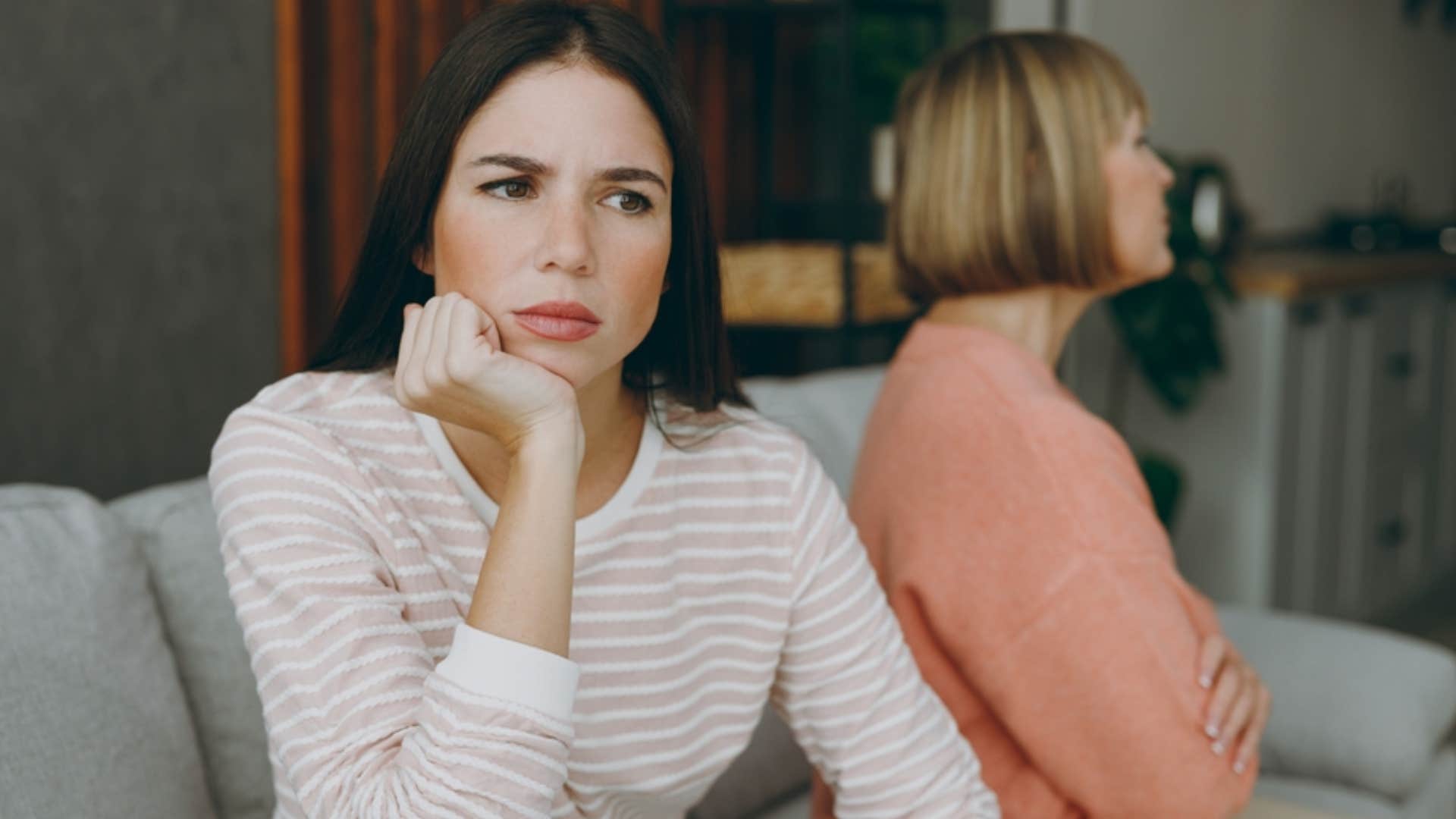 sad woman turned away from mother