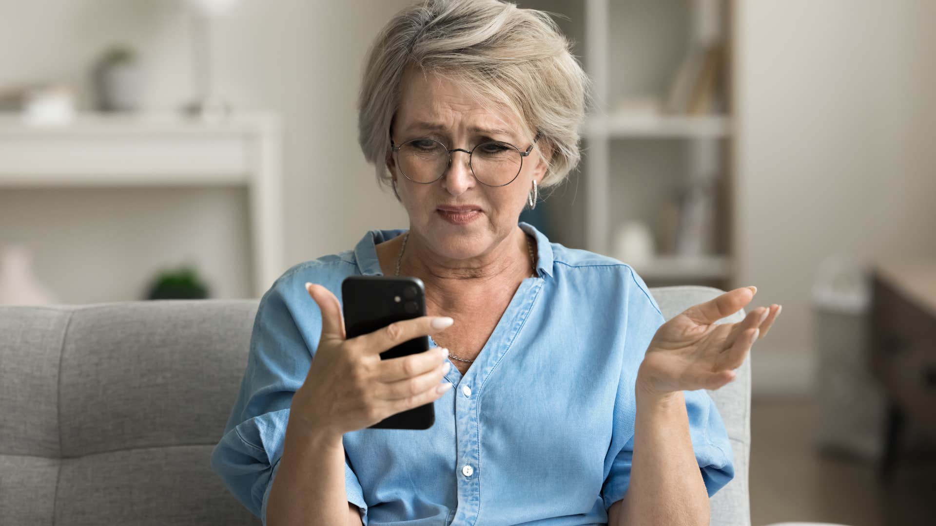 annoyed boomer woman looking at her phone