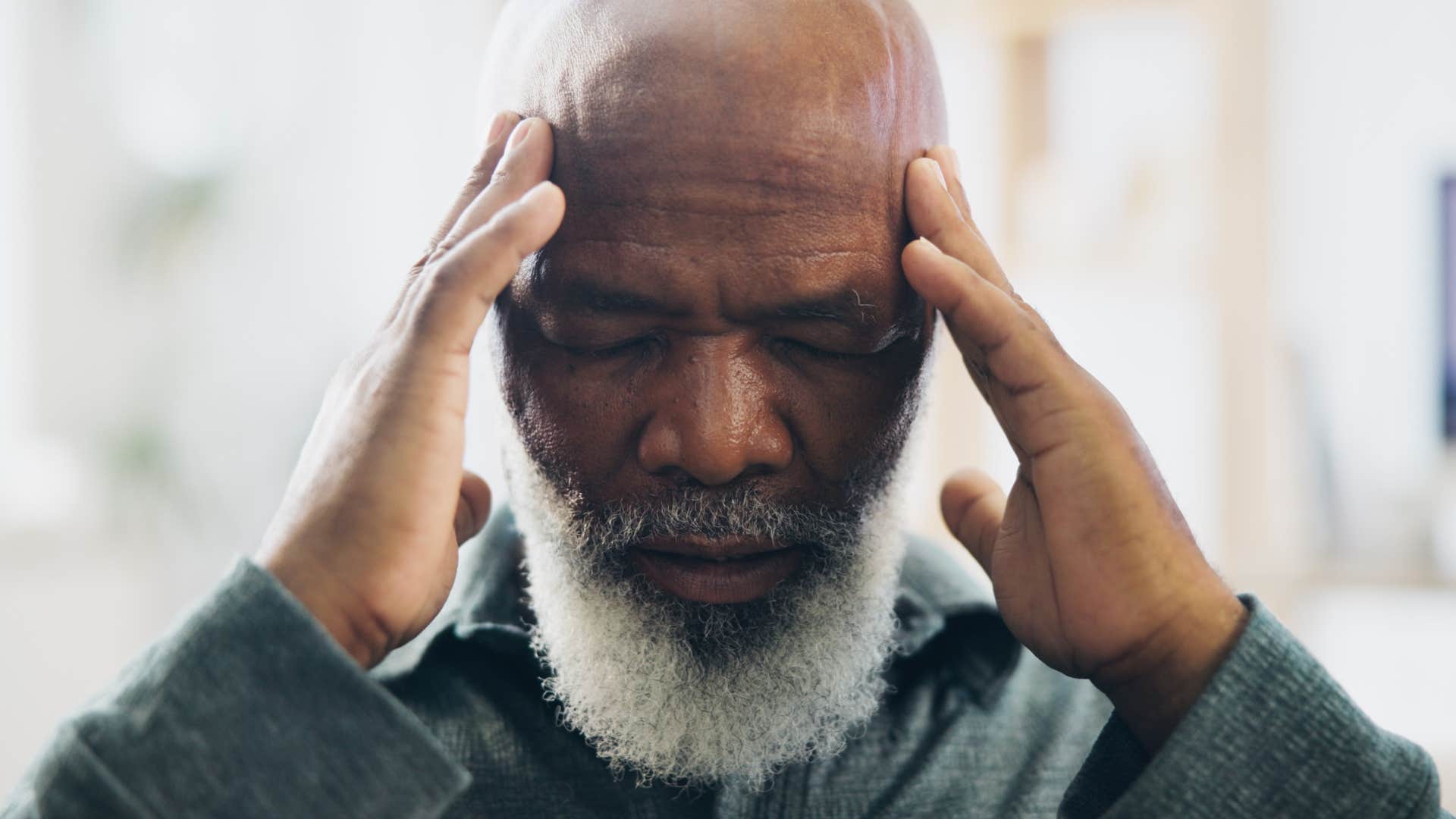 older upset man with headache