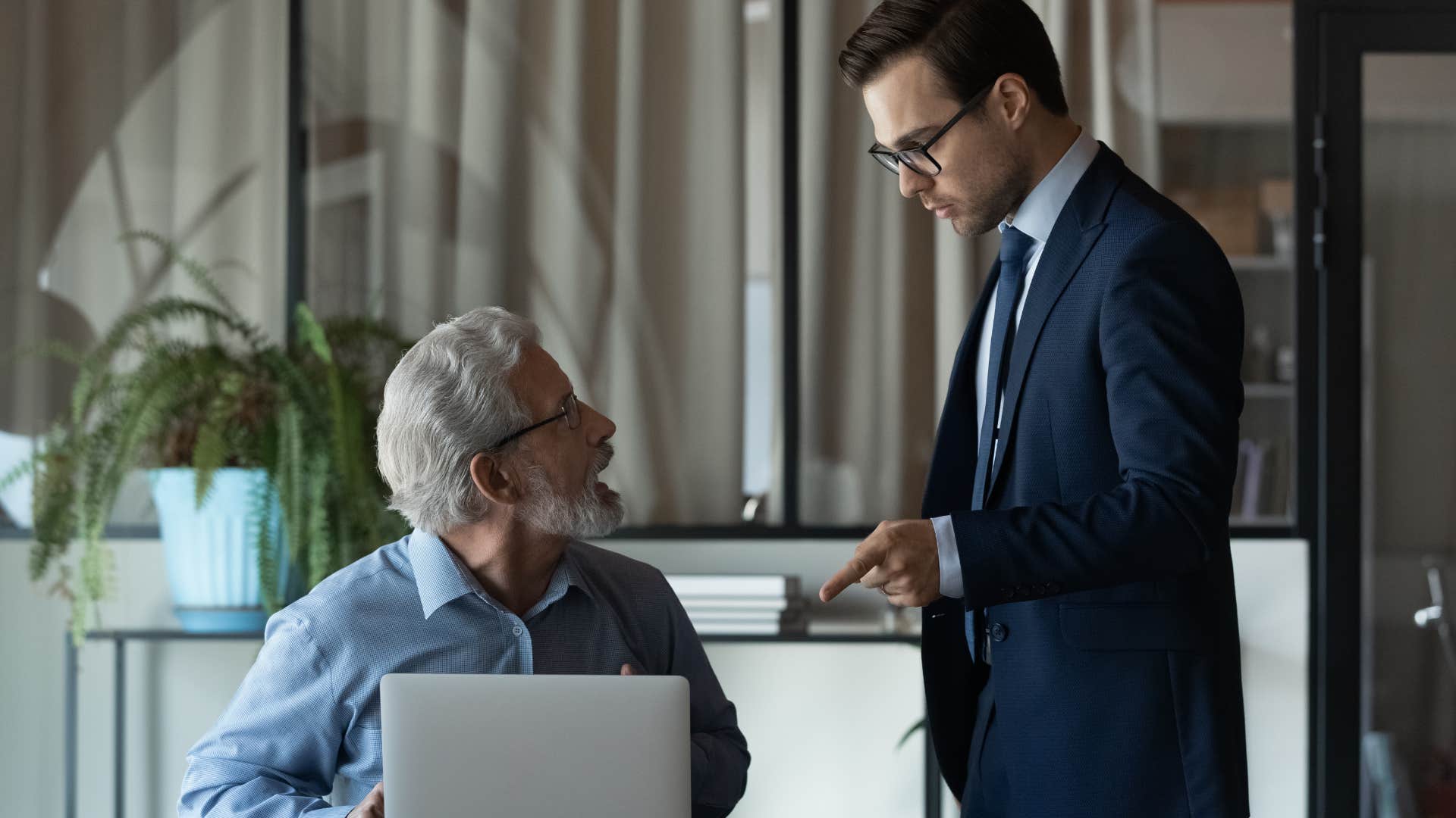 man arguing with older colleague