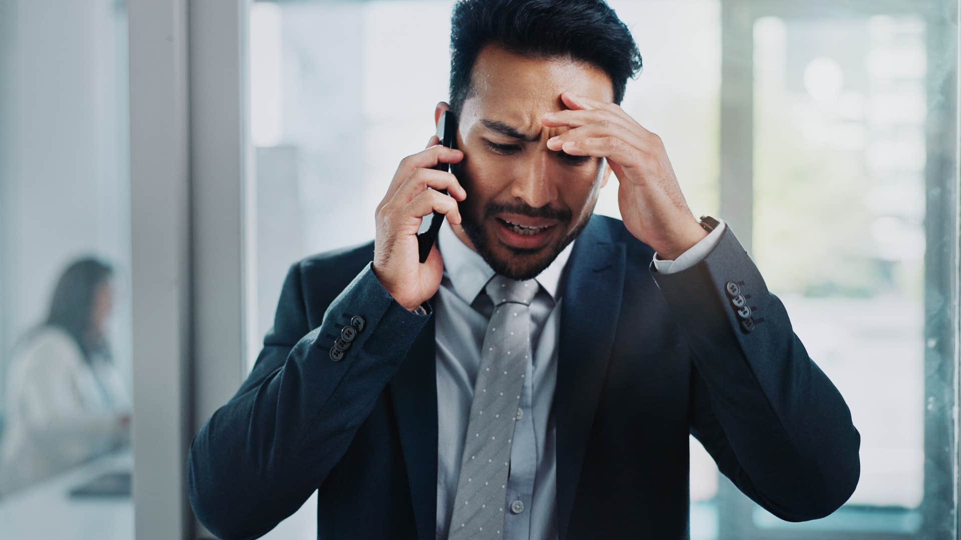 stressed man talking on phone