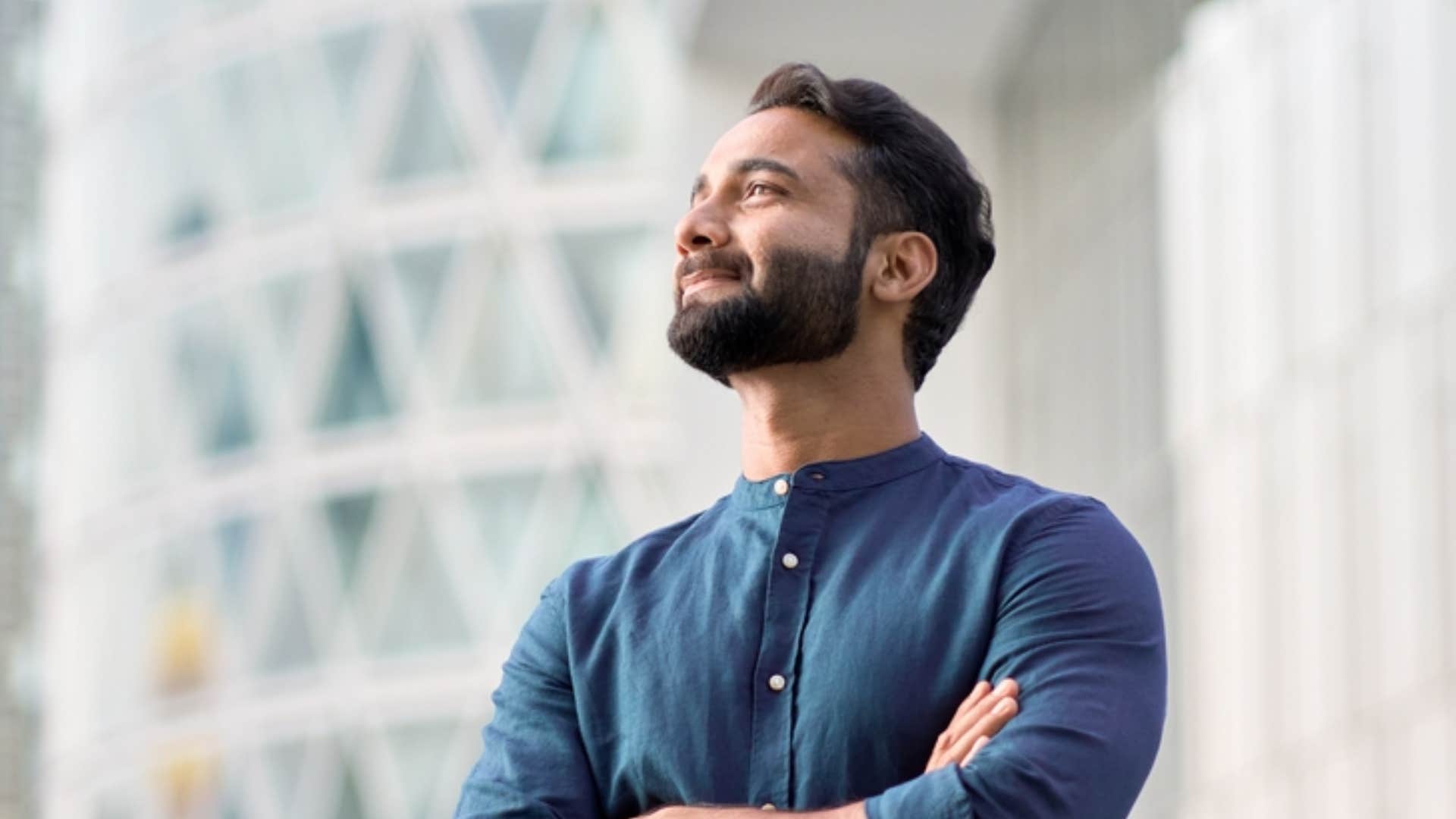 confident man smiling with his arms crossed