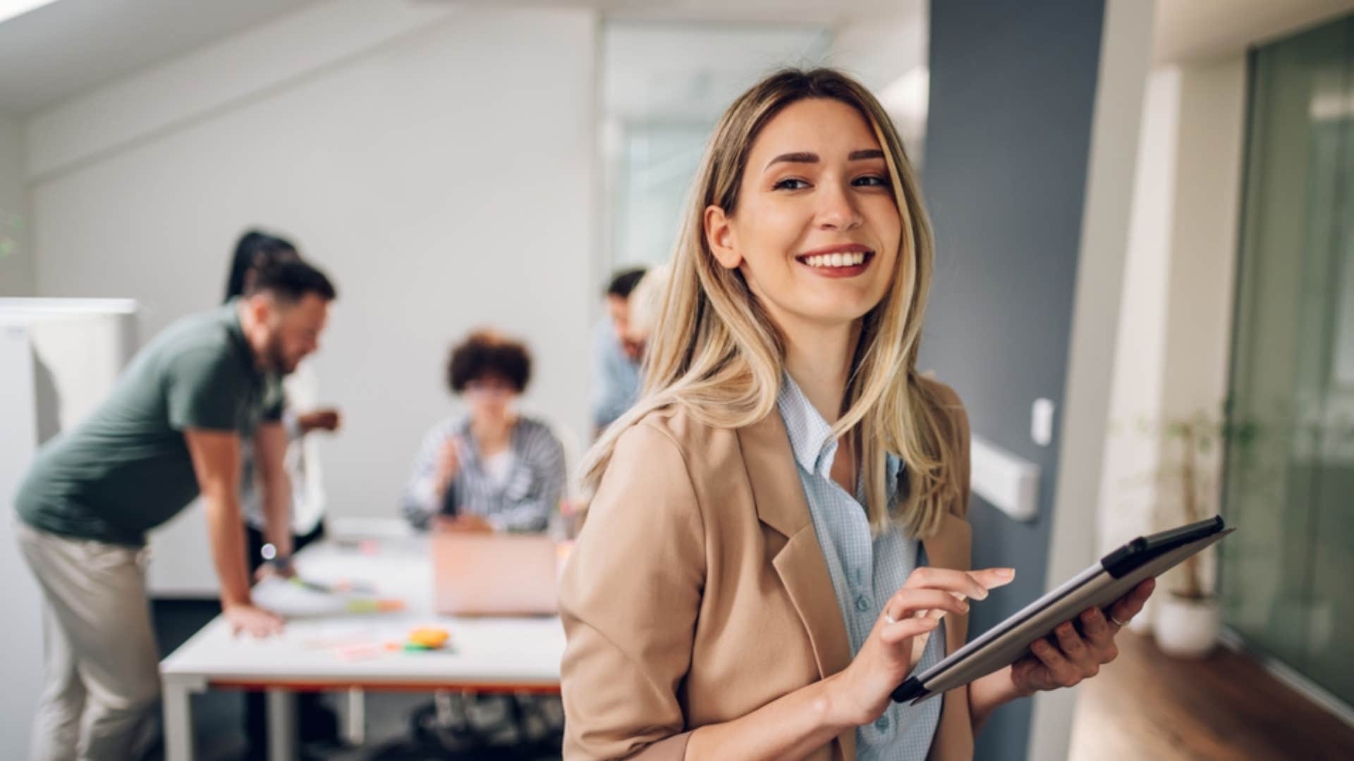 smiling businesswoman working on her tablet