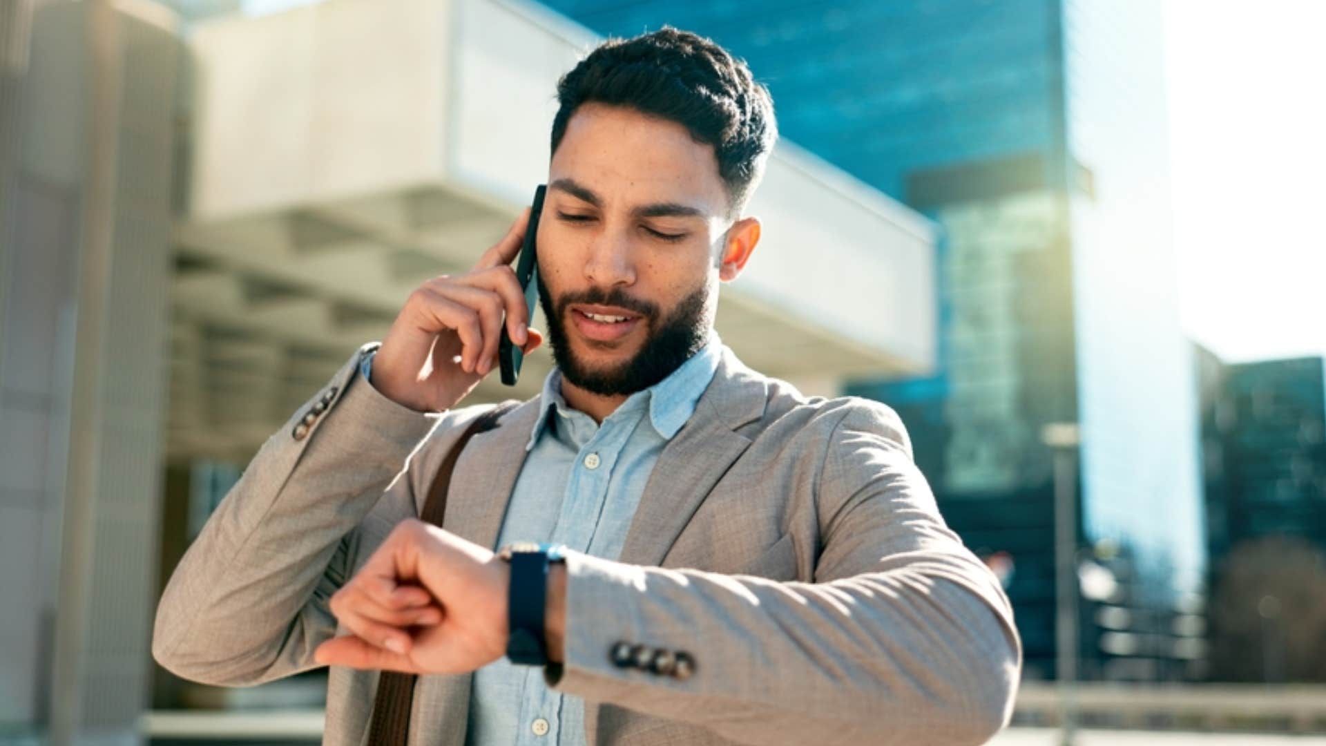 man looking at his wrist watch