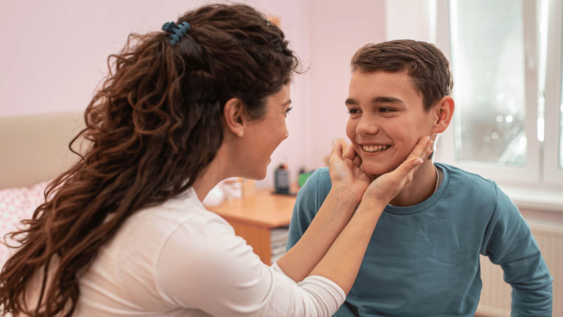 mom uplifting her son