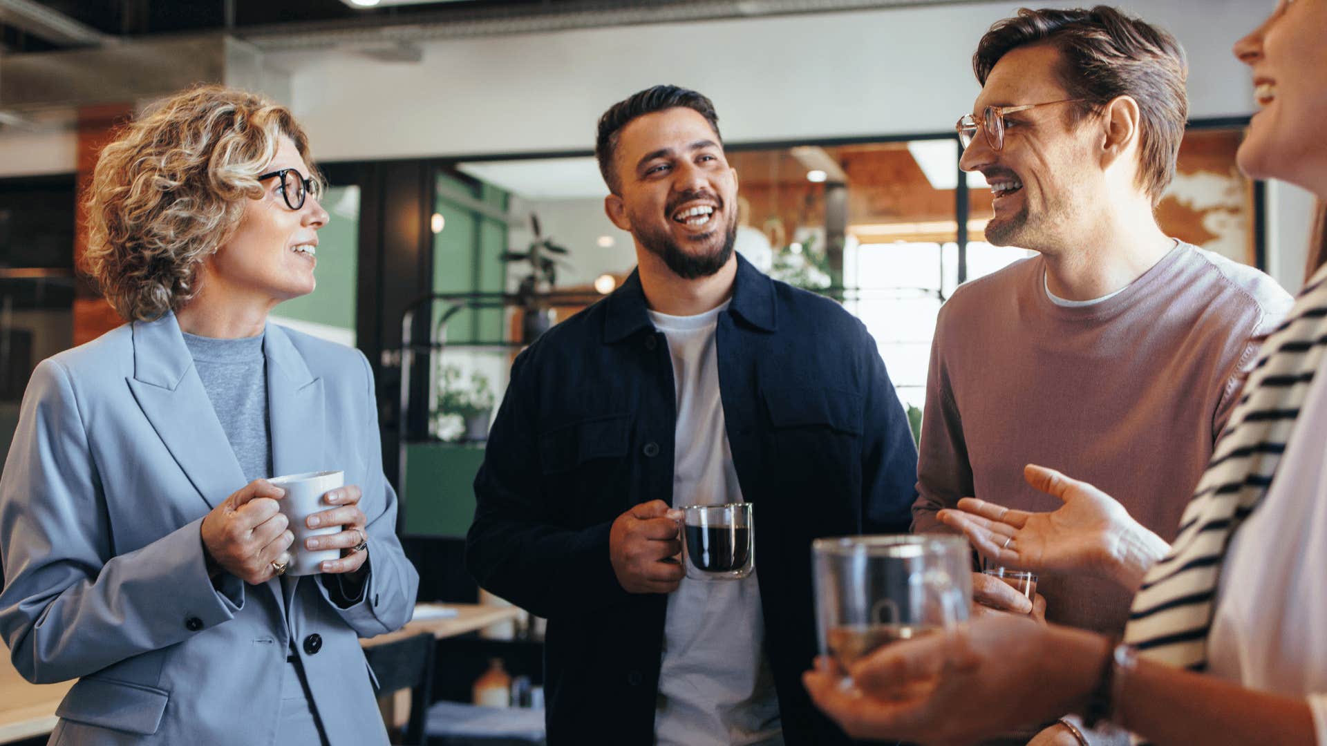 group of workers standing around drinking coffee