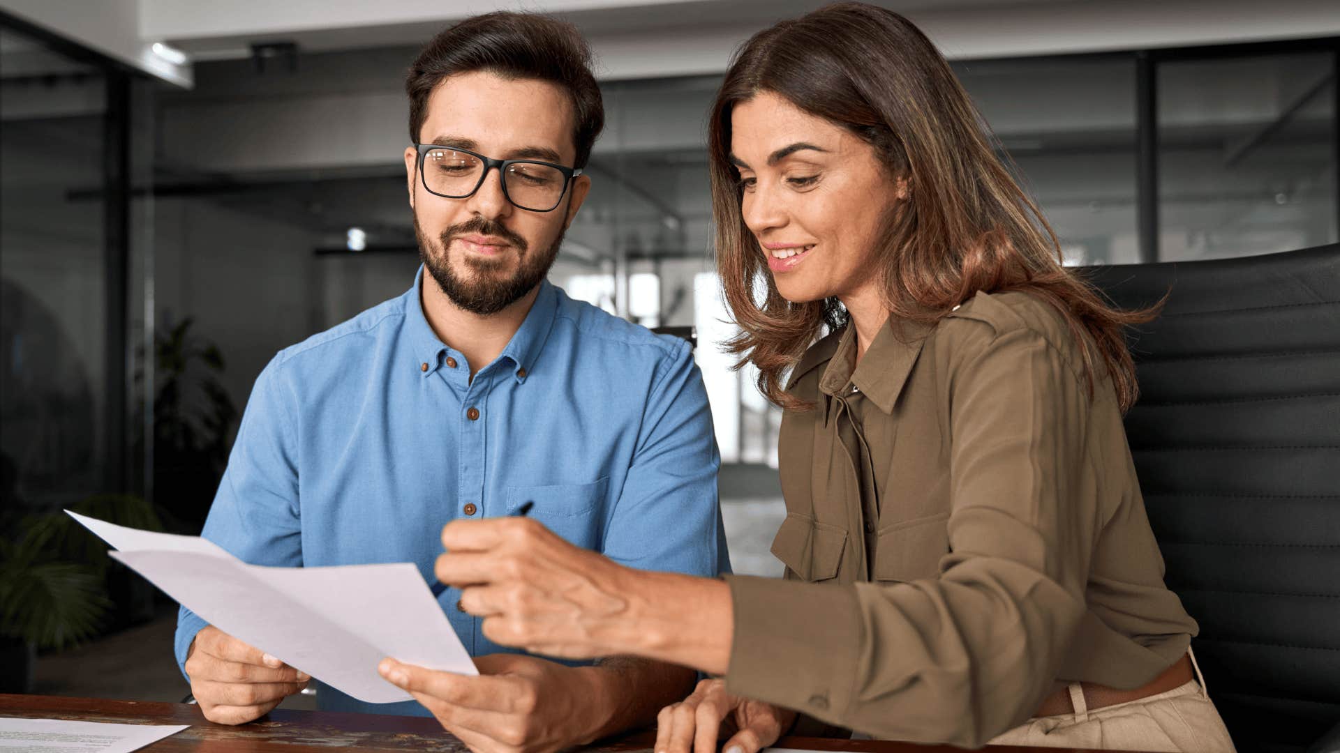 workers looking at potential employee resume