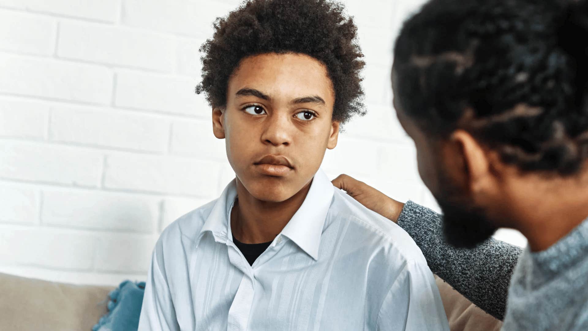 father offering advice to young son