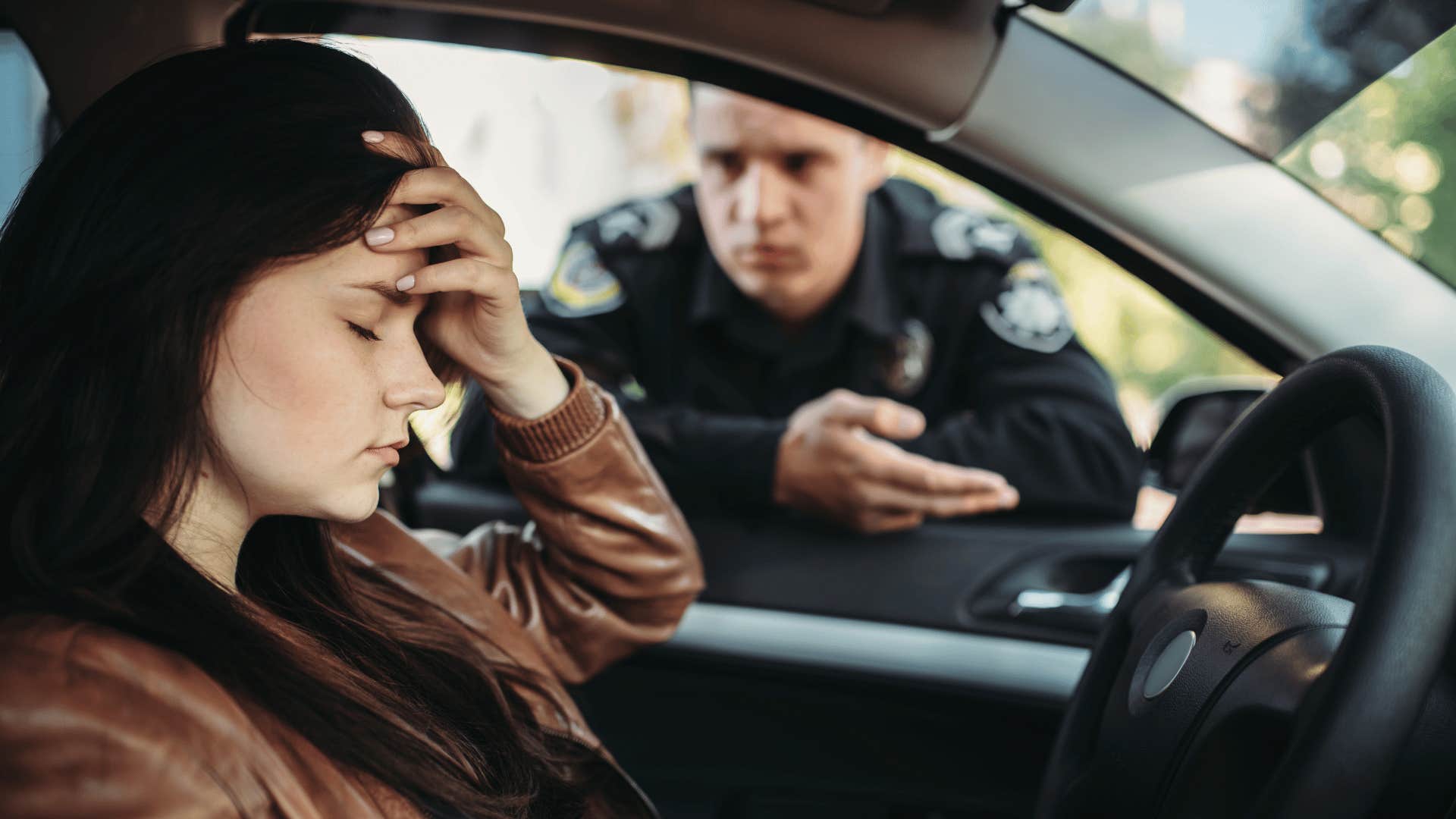 stressed woman getting pulled over by a cop