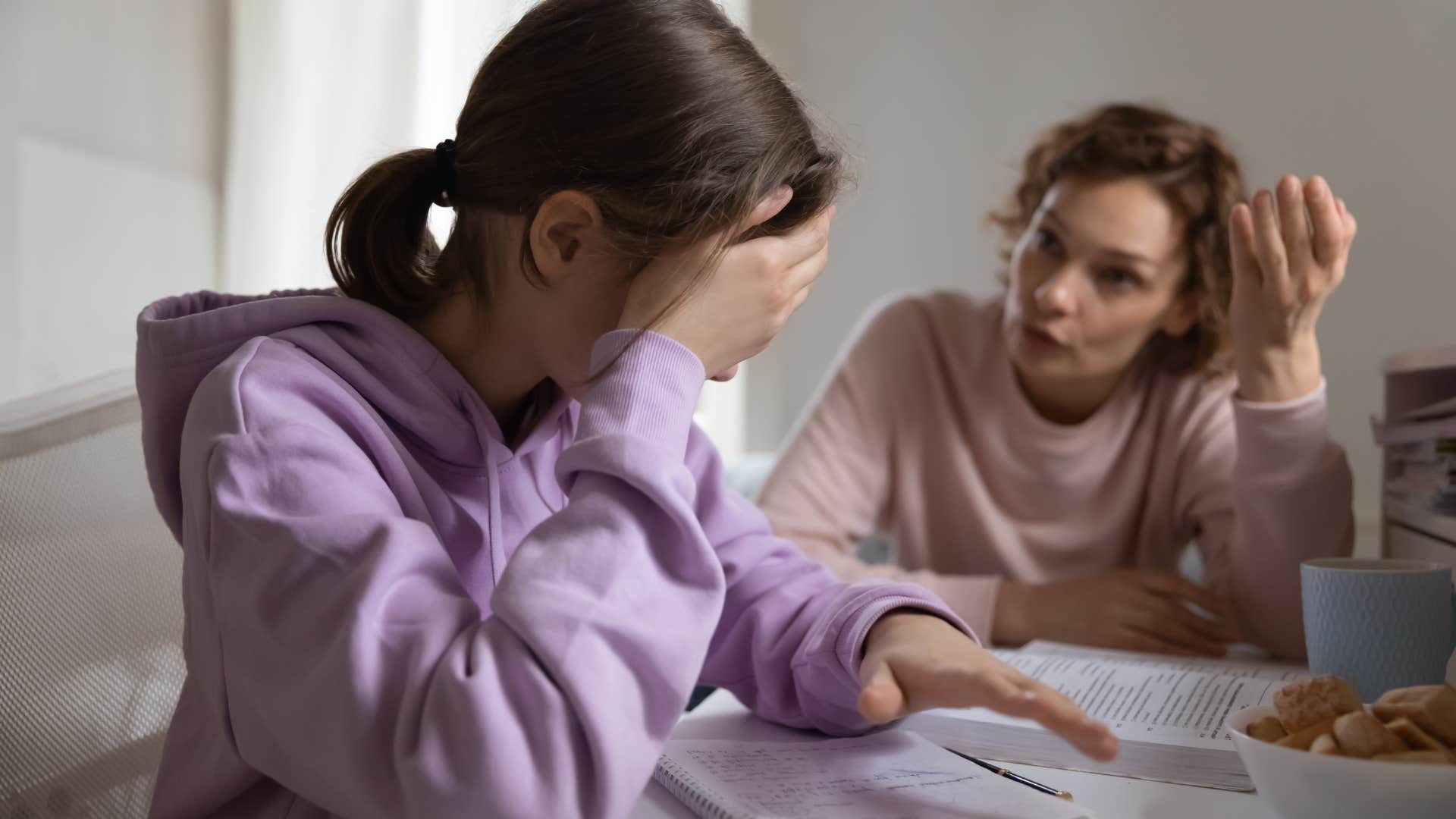 mother scolding upset teen daughter