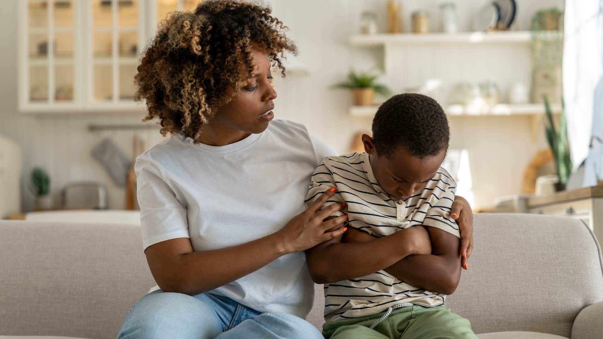 woman seeking emotional support from young upset son