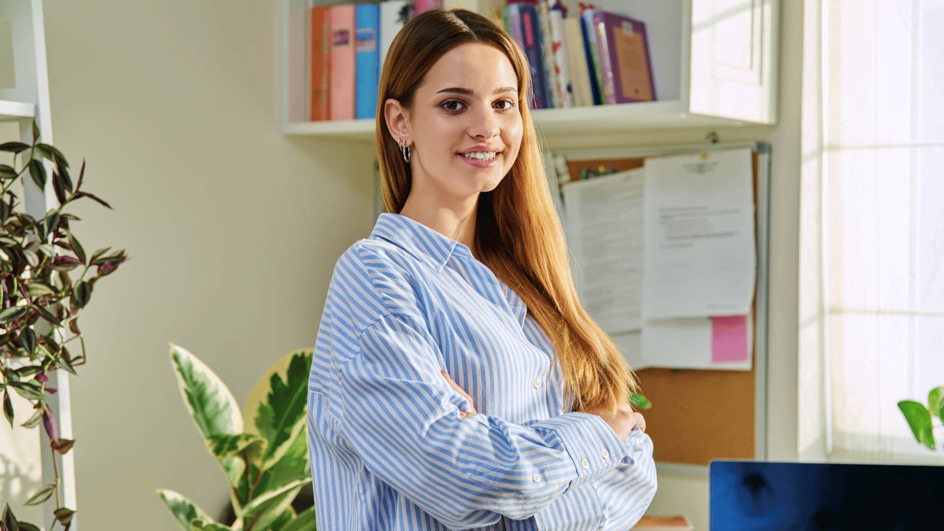 gen z woman crossing her arms and smiling 