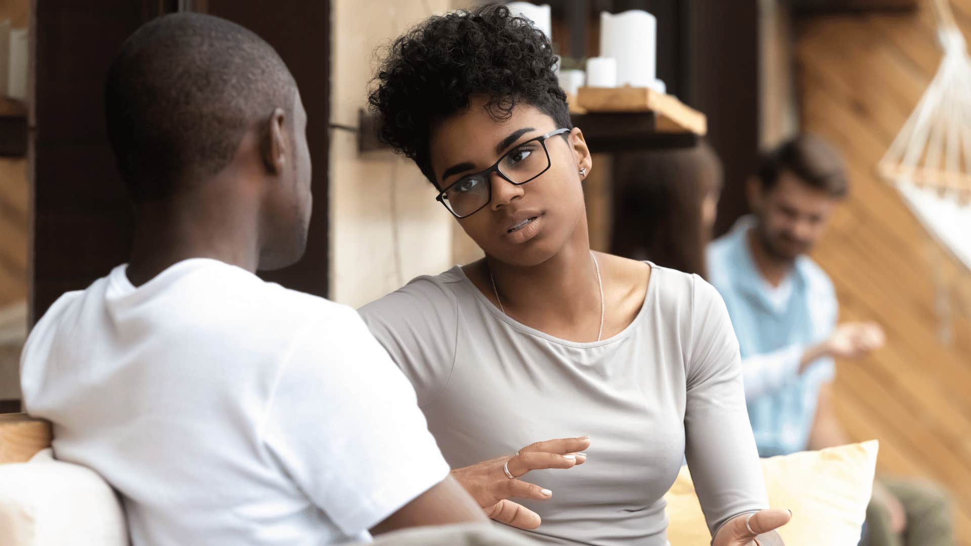 Untrusting couple tries not to be defensive while talking at cafe