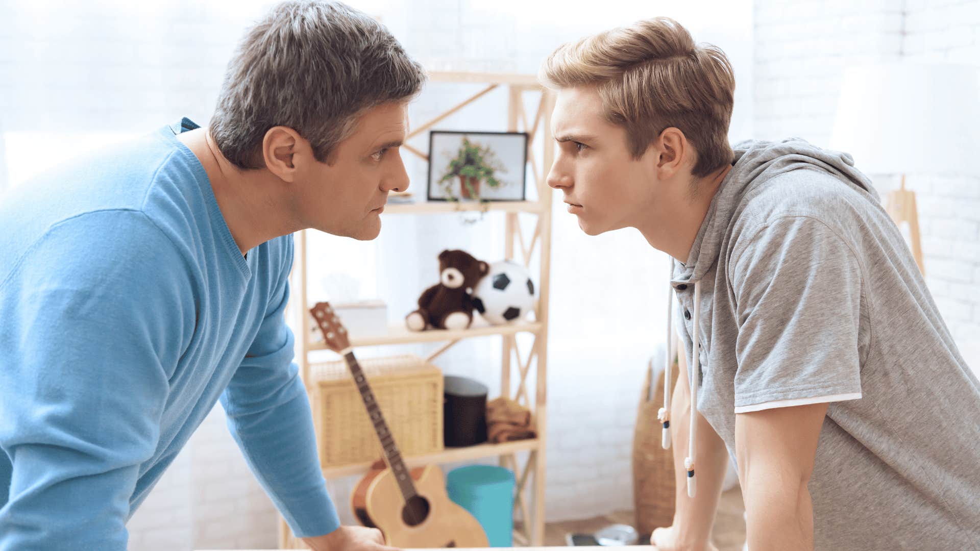 old-fashioned parent and son staring one another down