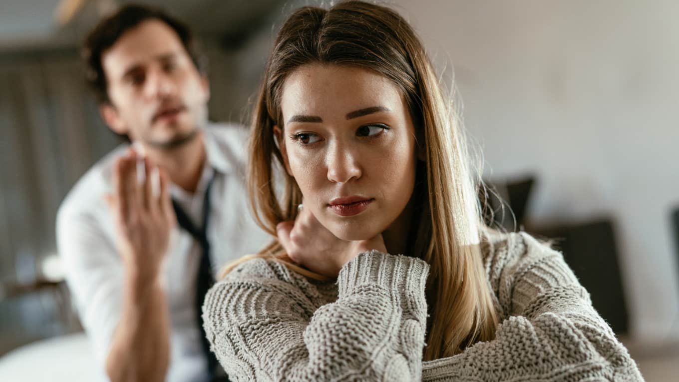 sad woman turned away from yelling man