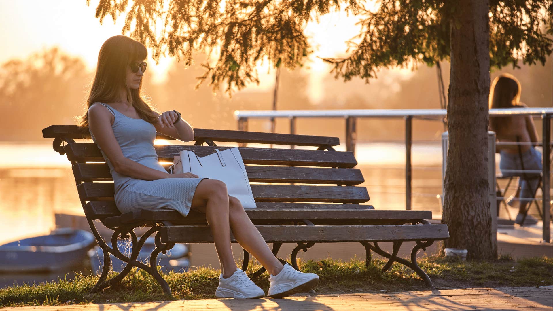 woman waiting on park bench