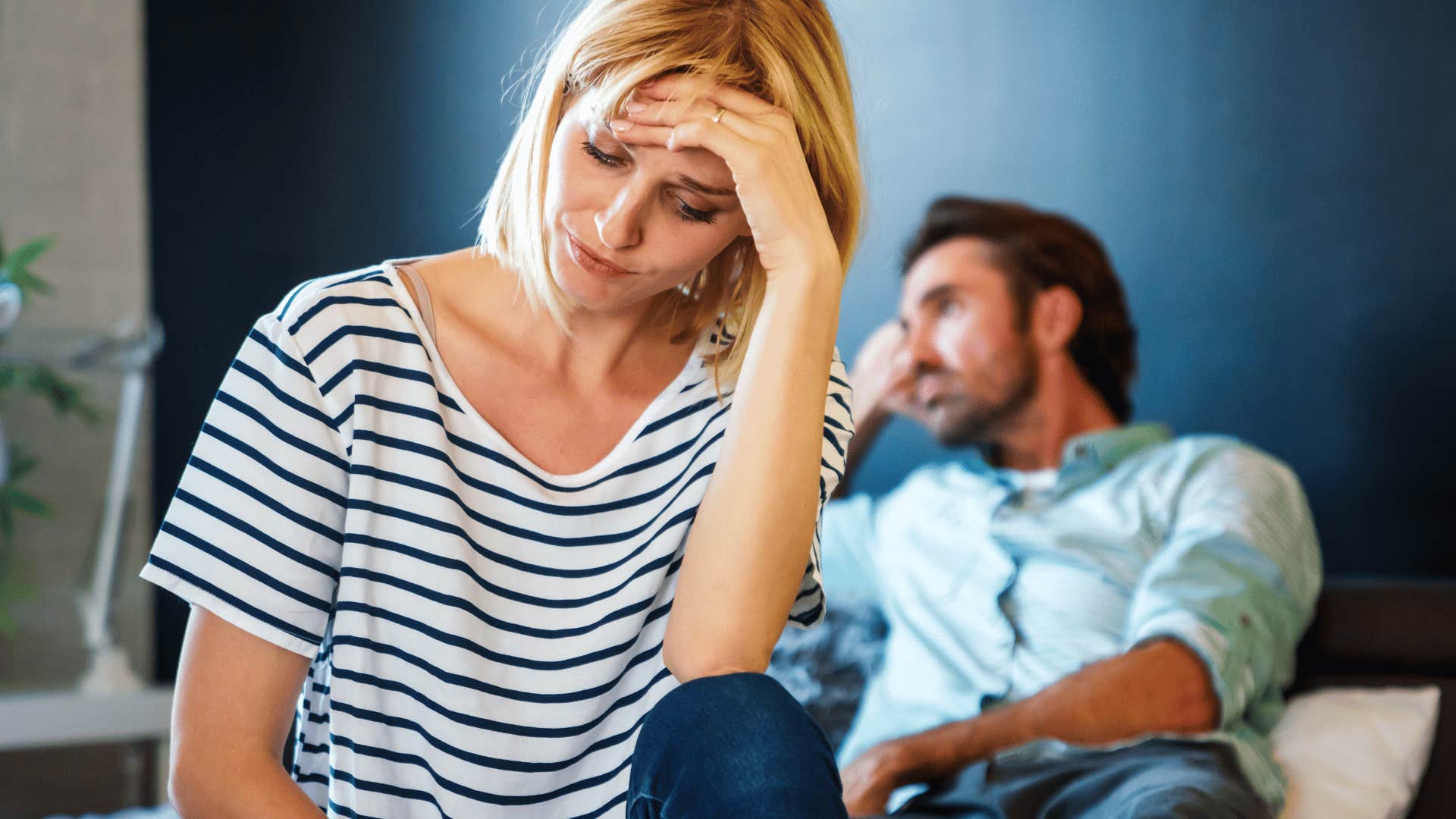 upset woman with man behind her